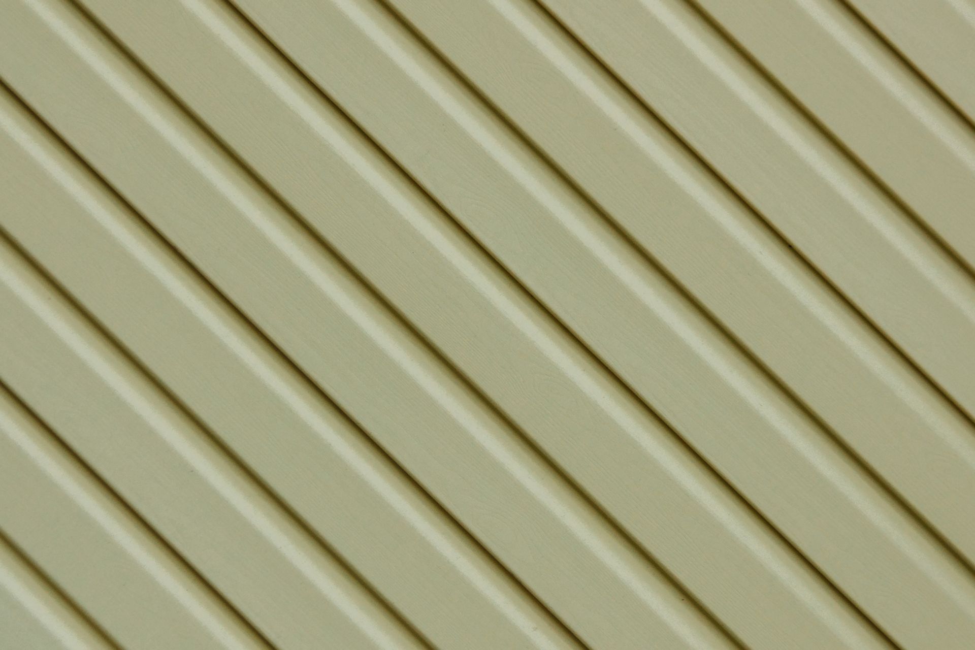 A close up of a green siding with diagonal stripes