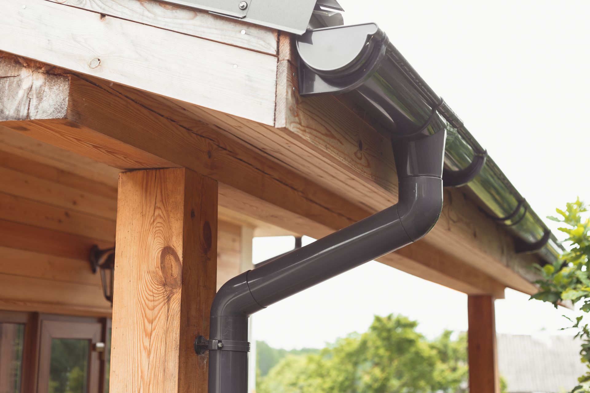 A close up of a gutter on the side of a house.