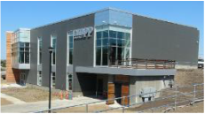 A large building with a lot of windows and a sign that says happy