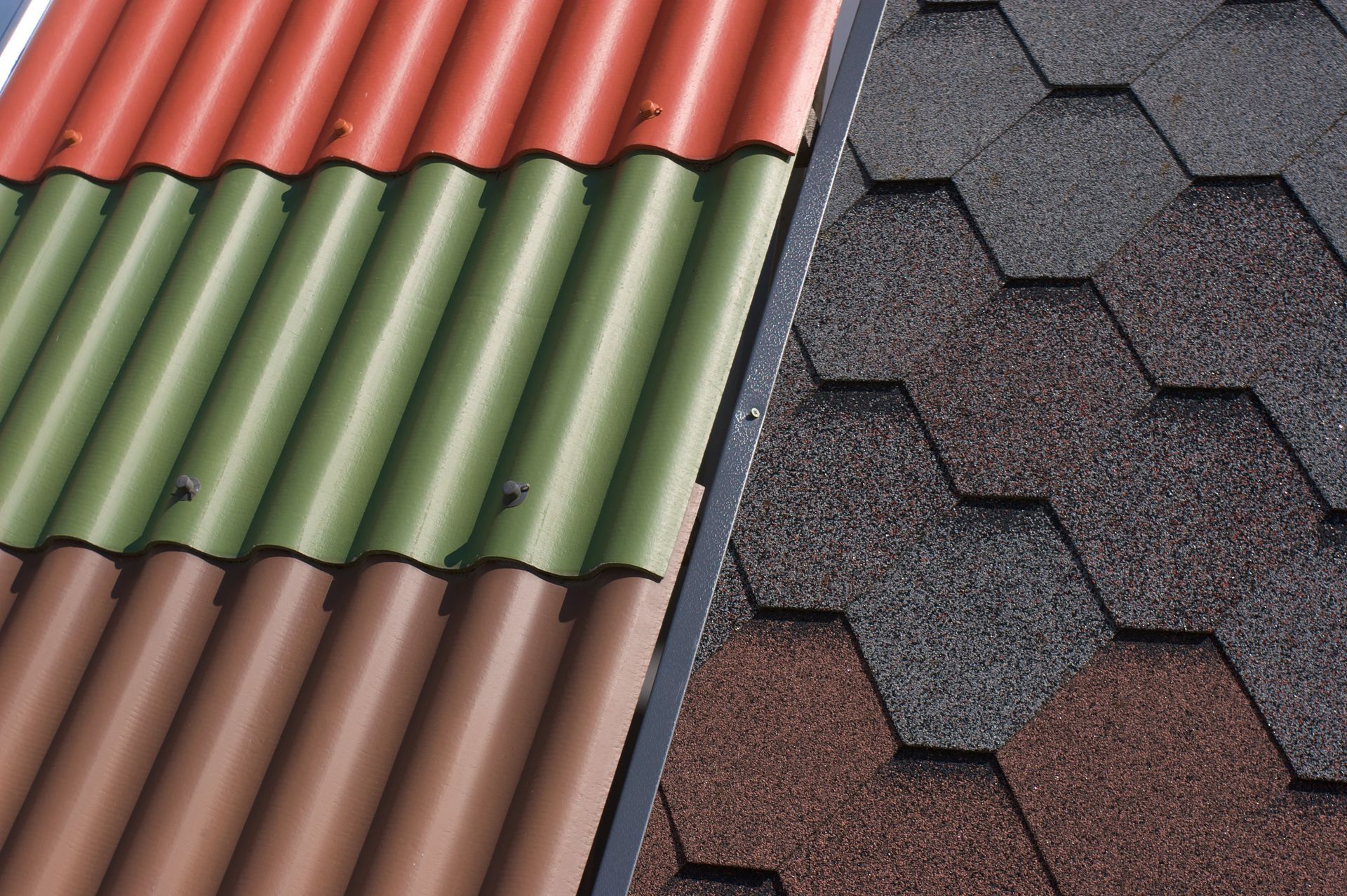 Image of various roofing materials, such as metal shingles and asphalt shingles. 