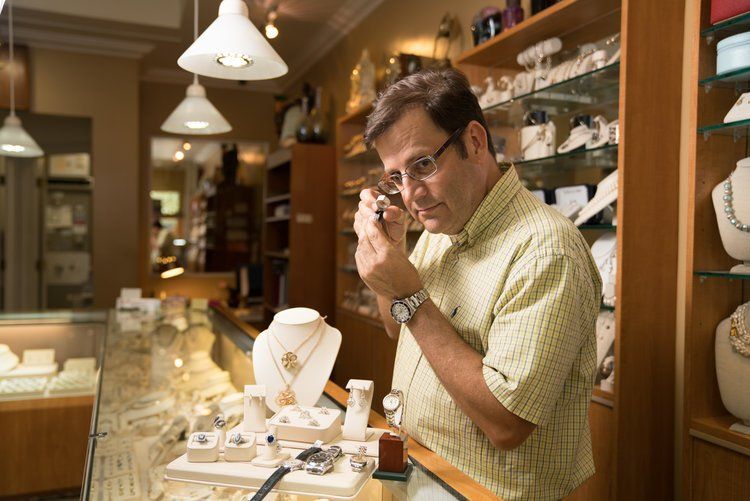 Man Examining the Watch — Winter Park, FL — Reynolds & Co. Jeweler