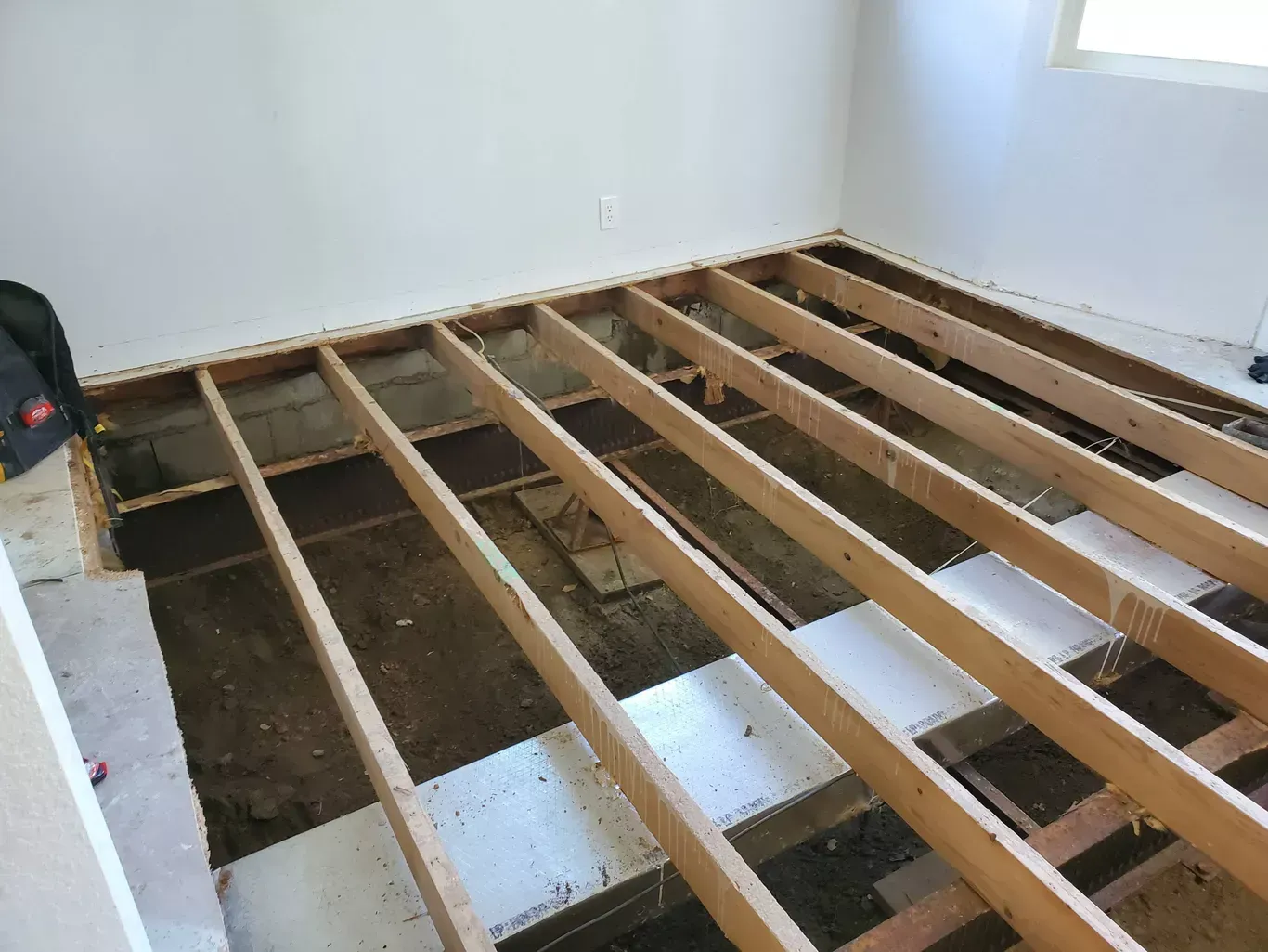 A wooden floor is being built in a room.