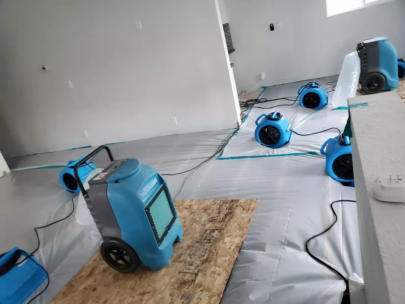 A room with a lot of blue appliances on the floor.