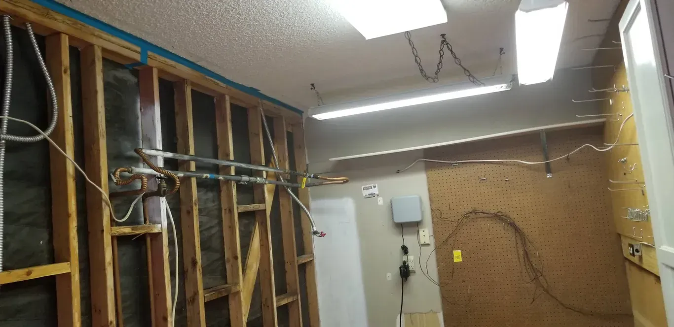 A room with a lot of wires hanging from the ceiling.