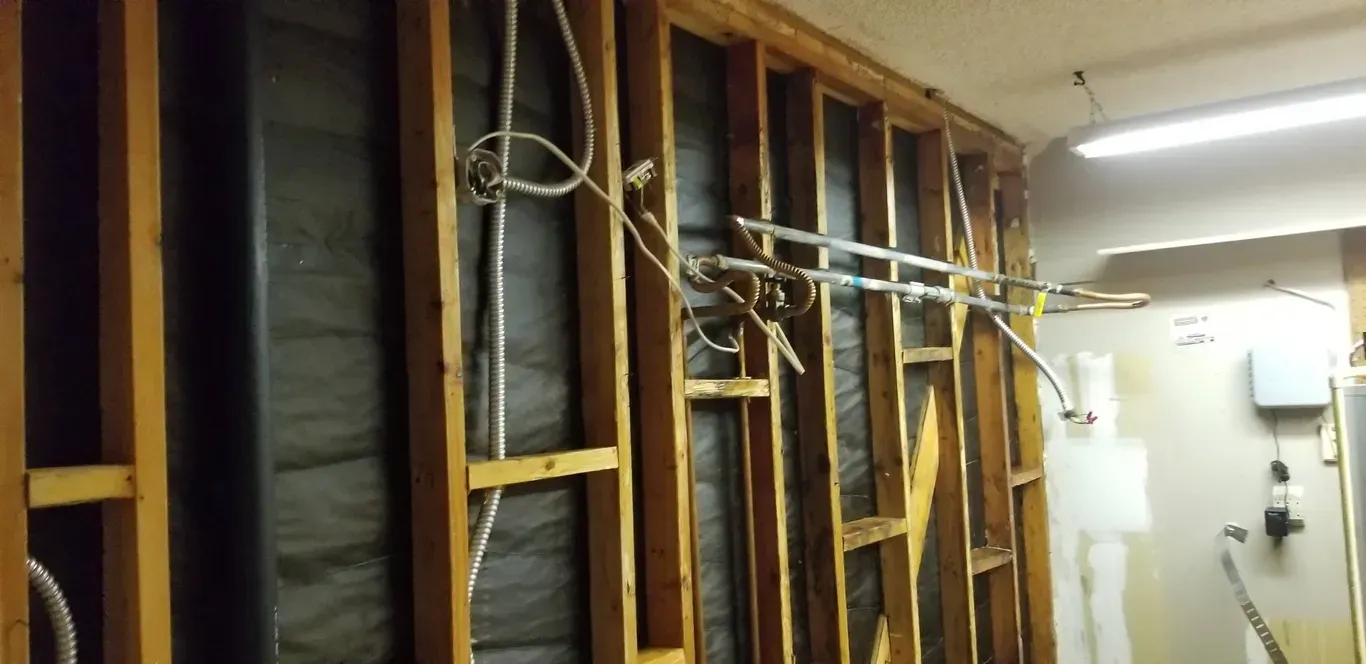 A wooden wall with a lot of wires hanging from it