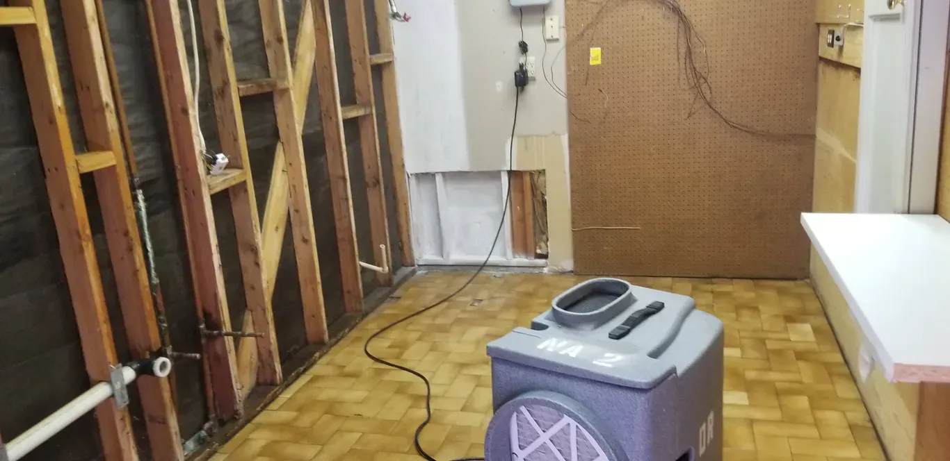 A room with wooden walls and a vacuum cleaner on the floor.
