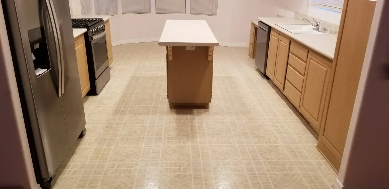 A kitchen with stainless steel appliances and wooden cabinets.