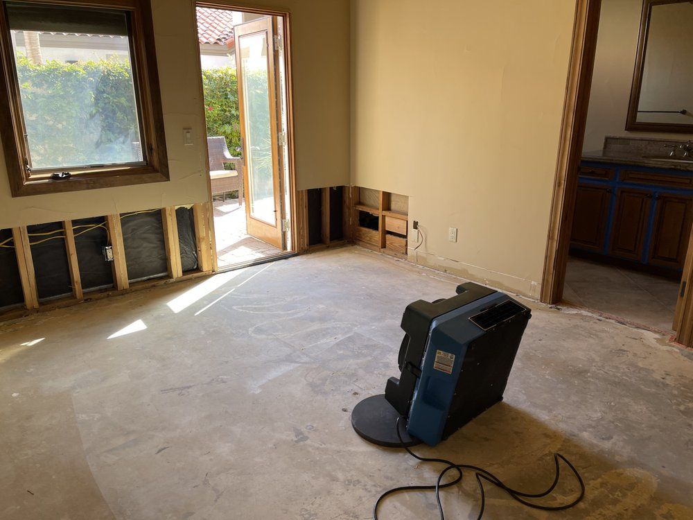 A room with a sliding glass door and a tv on the floor.