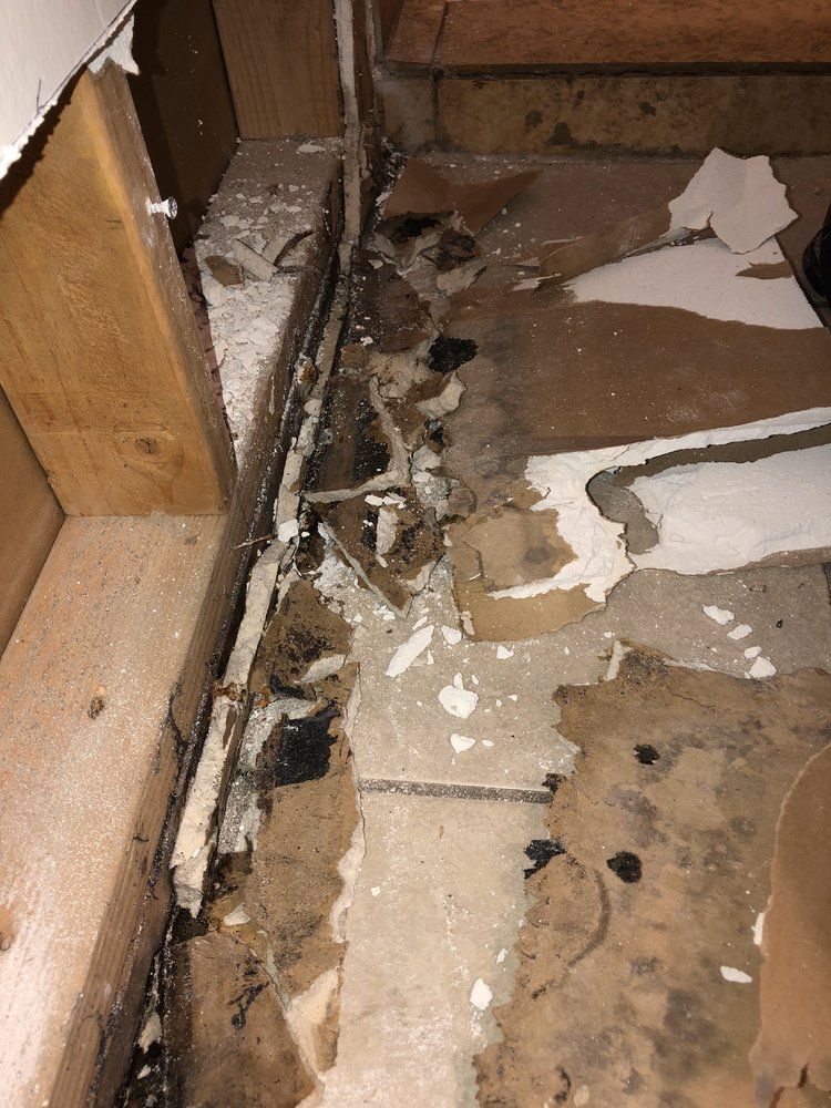 A room with a lot of damage to the floor and walls.