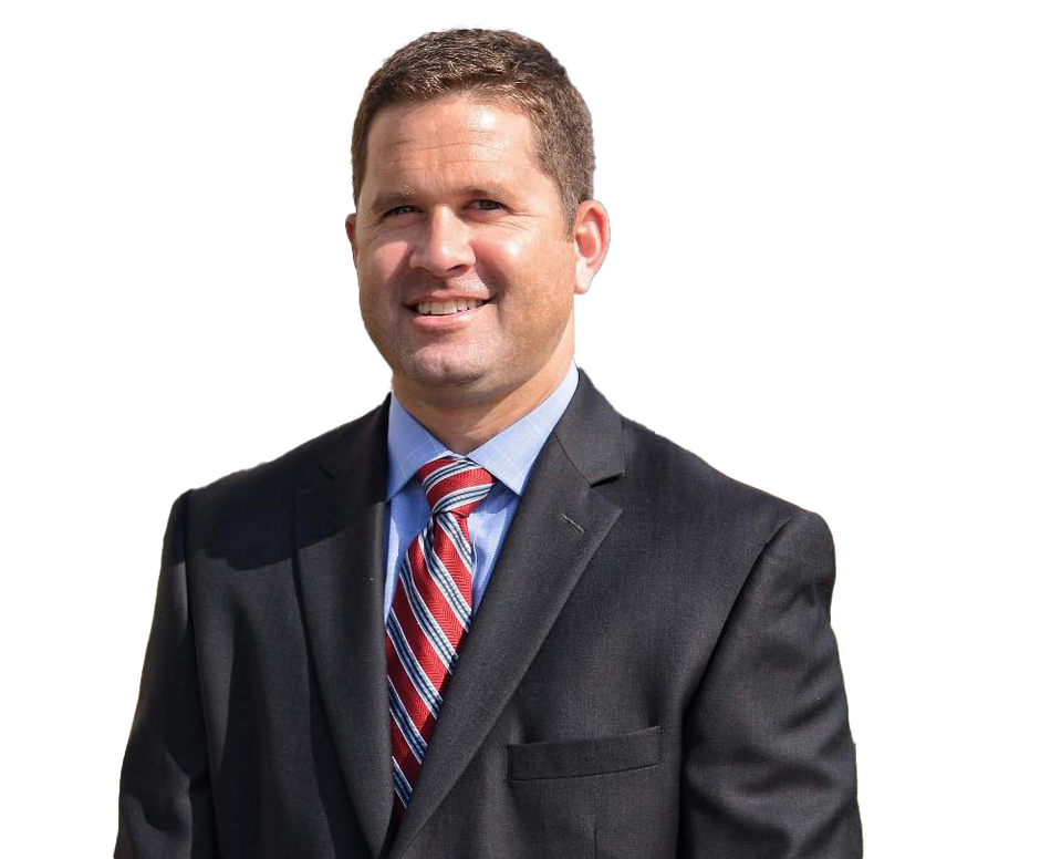 A man in a suit and tie is smiling for the camera