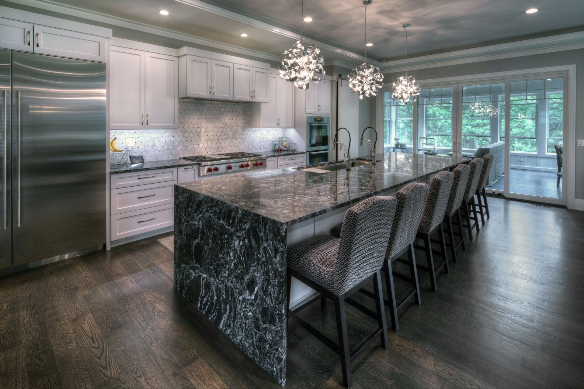 A large kitchen with stainless steel appliances and a large island.