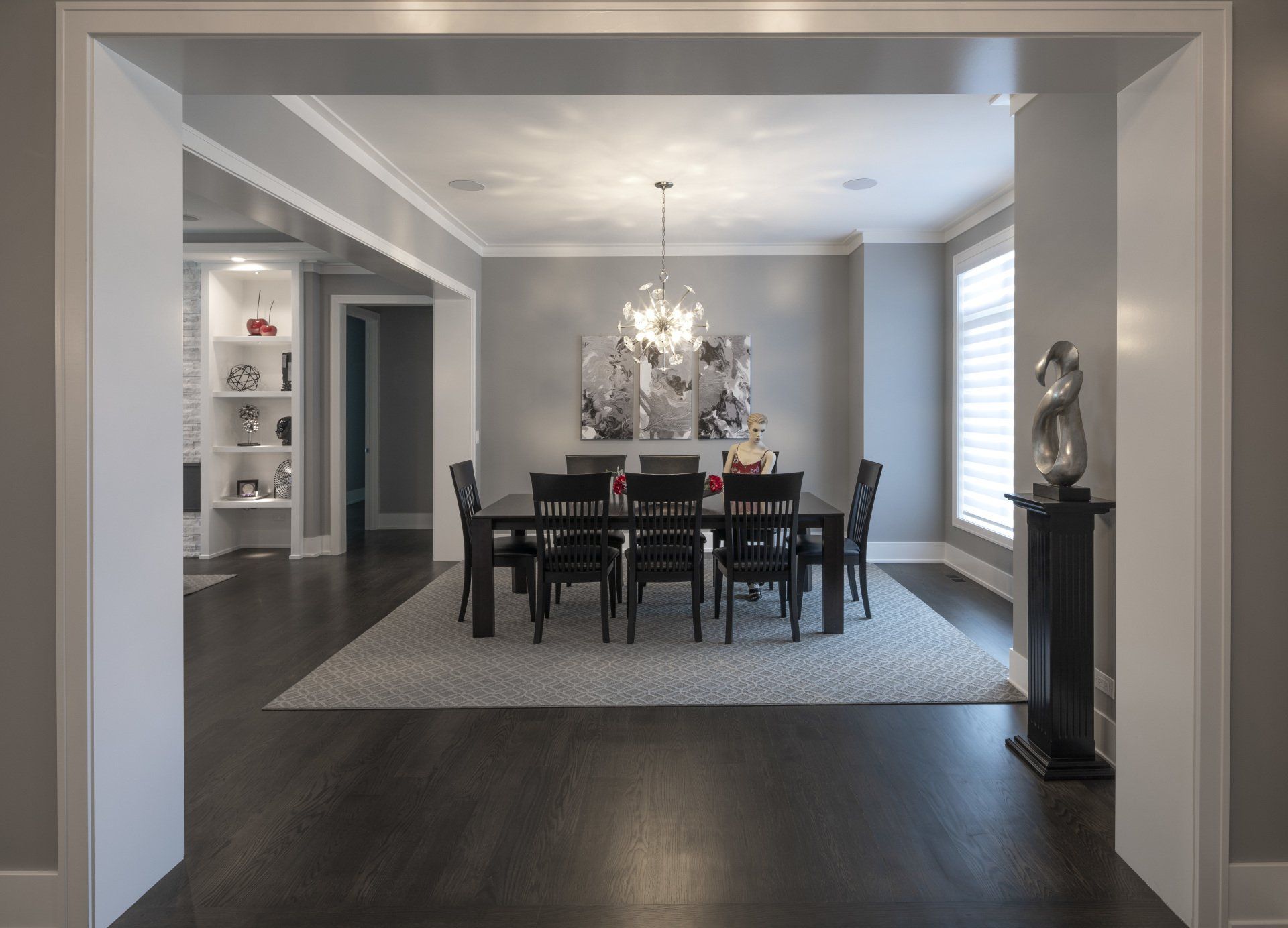 A dining room with a table and chairs in it