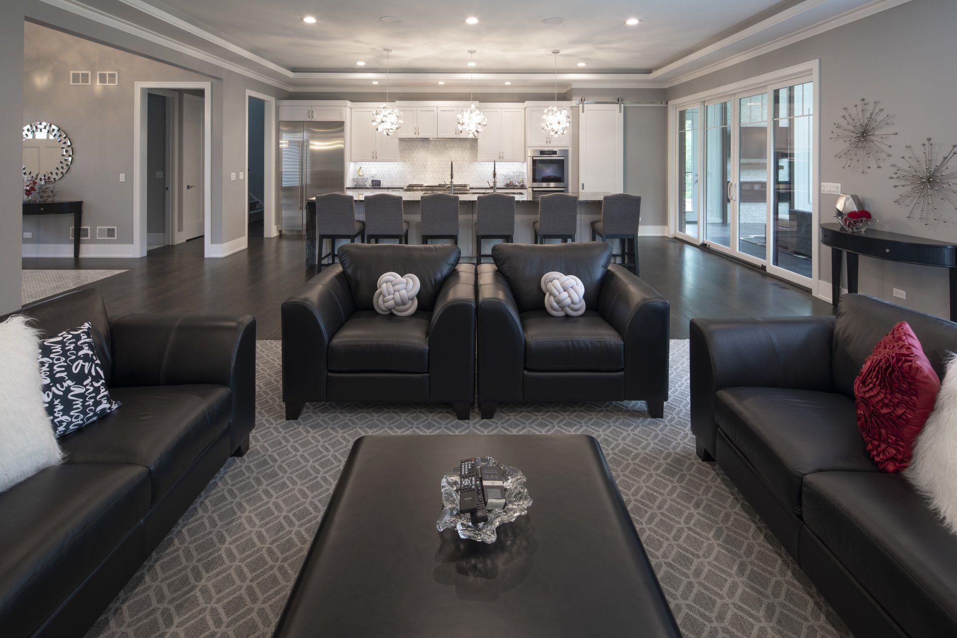 A living room filled with black furniture and a coffee table.