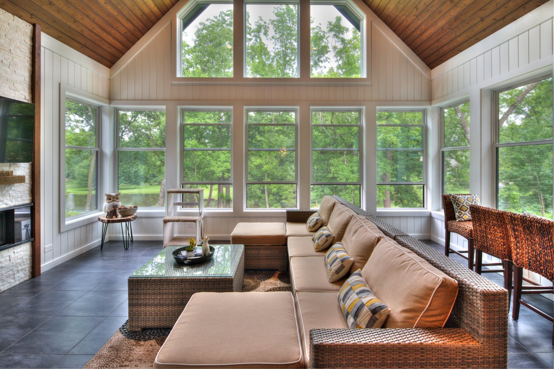 A living room with a lot of windows and a couch