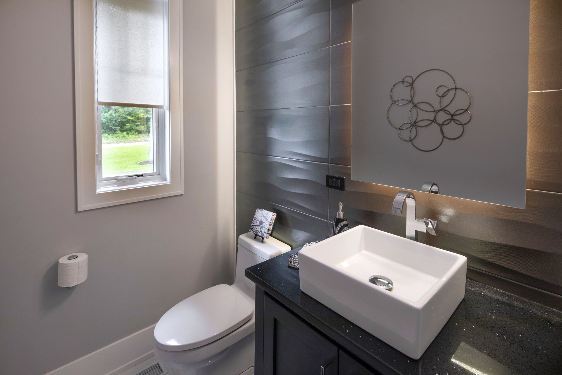 A bathroom with a toilet , sink and mirror