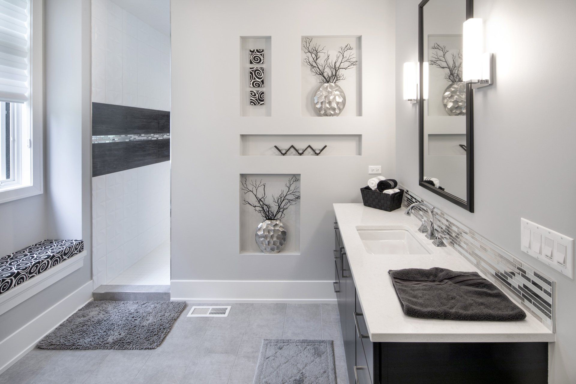A bathroom with two sinks , a mirror and a window.