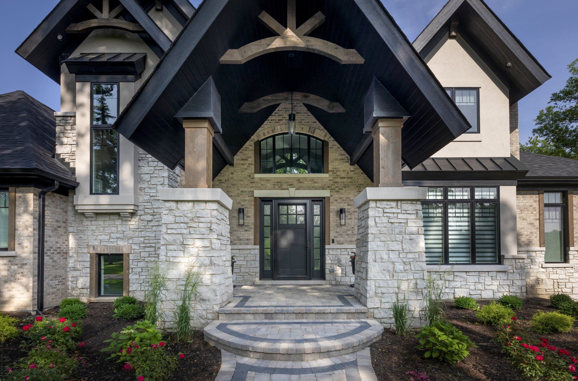 A large house with a stone facade and a black door