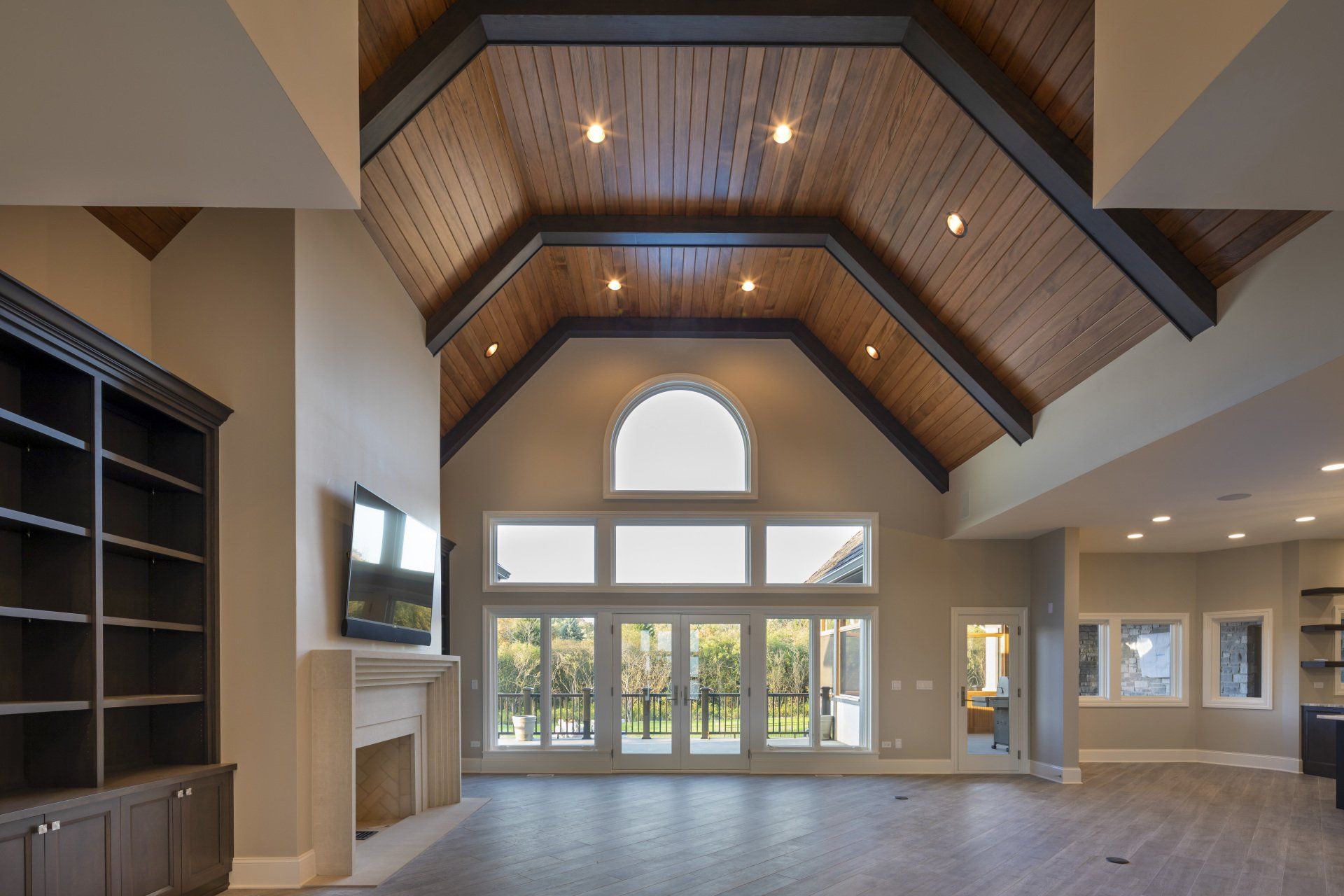 A living room with a vaulted ceiling and lots of windows