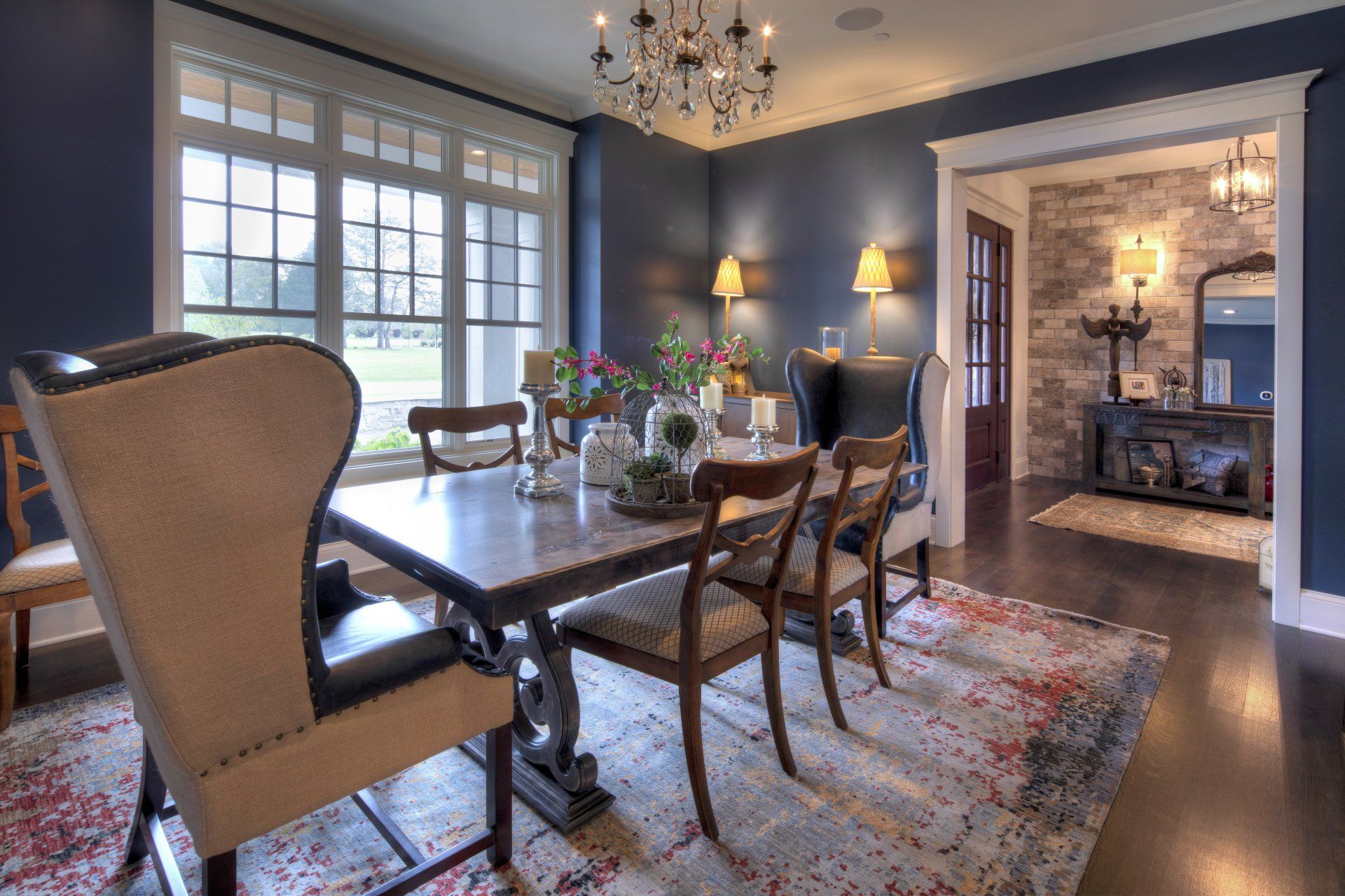 A dining room with a table and chairs and a chandelier.