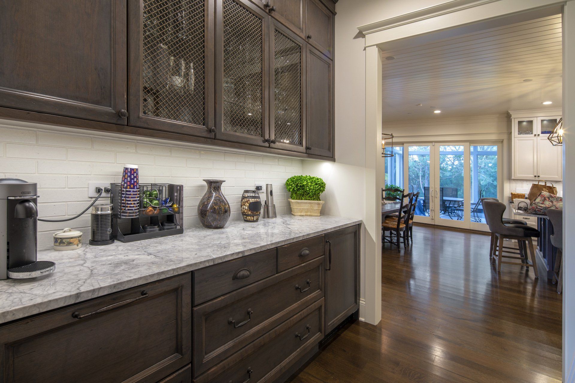 A kitchen with a lot of cabinets and a coffee maker on the counter.