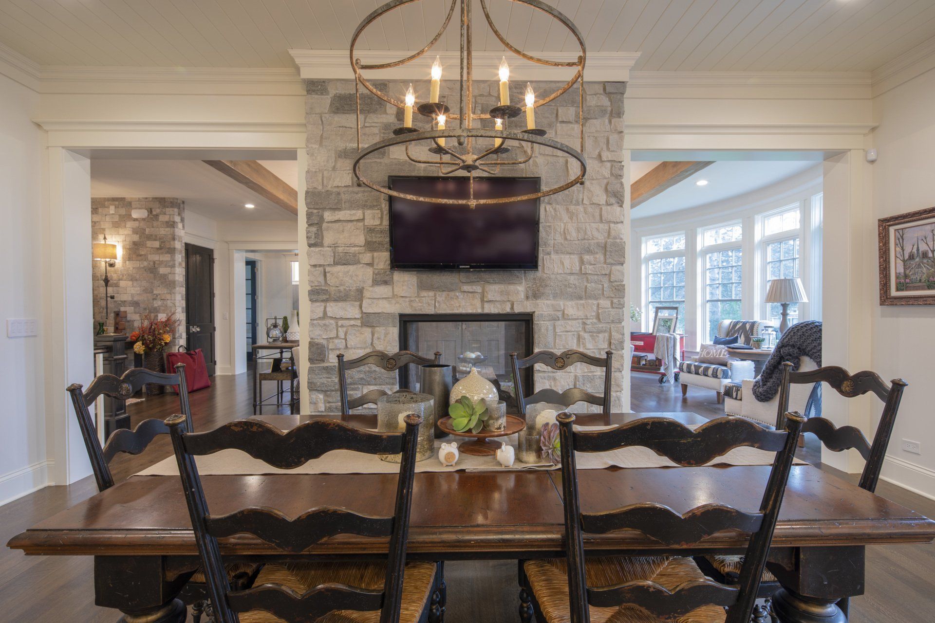A dining room with a table and chairs and a fireplace.