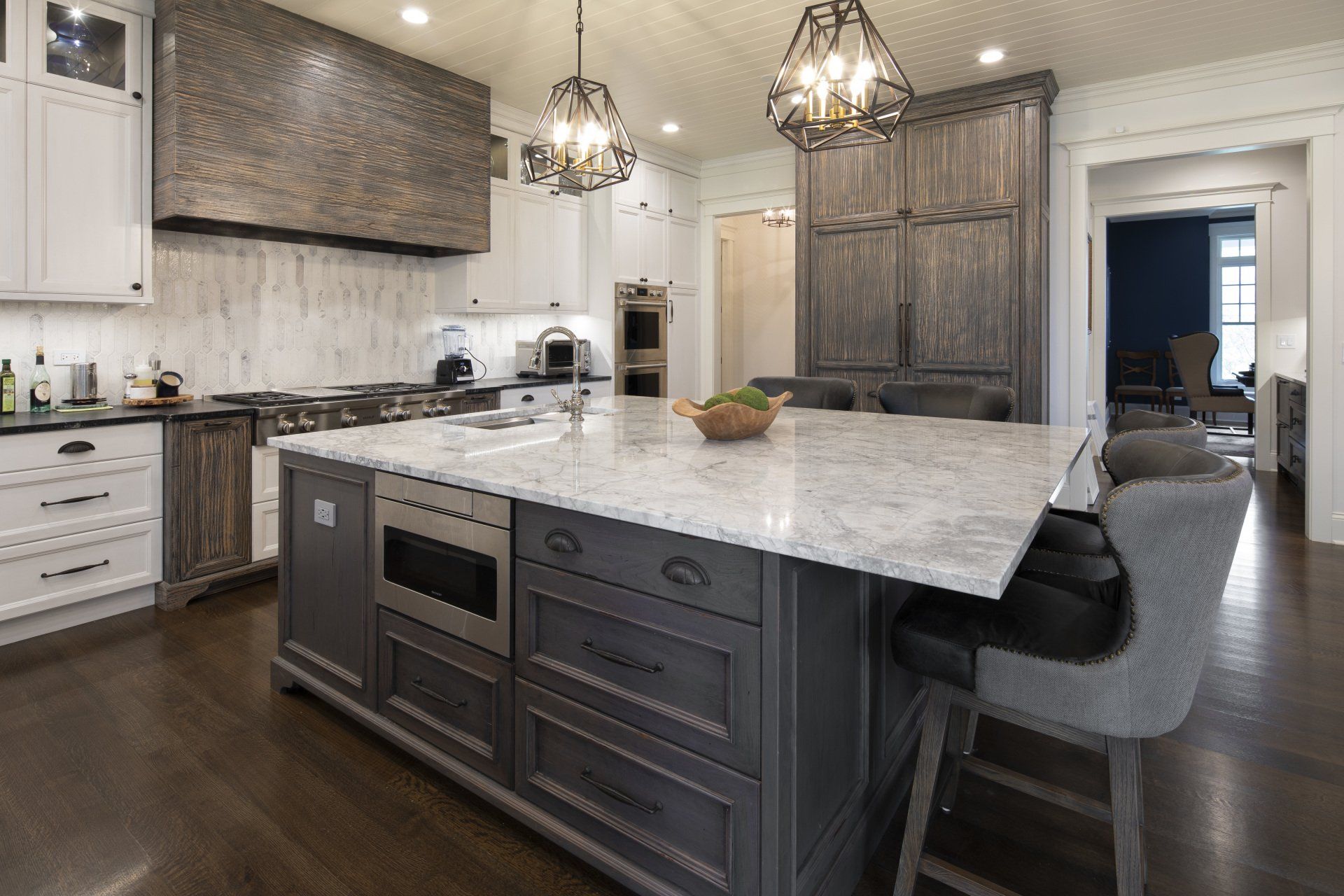 There is a large island in the middle of the kitchen.