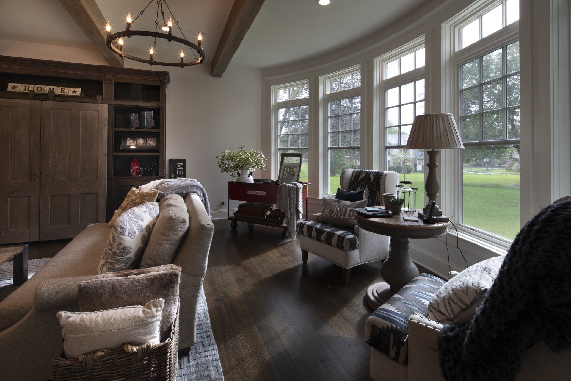 A living room with a lot of windows and a chandelier