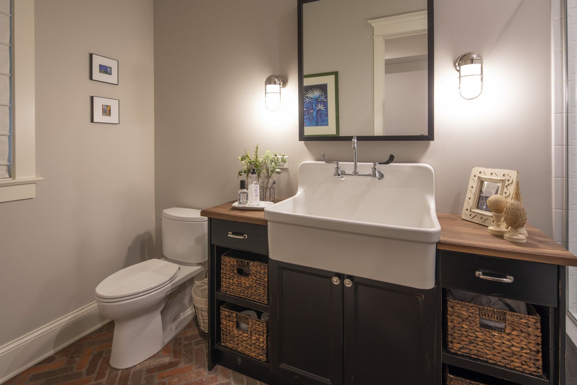 A bathroom with a sink , toilet and mirror.
