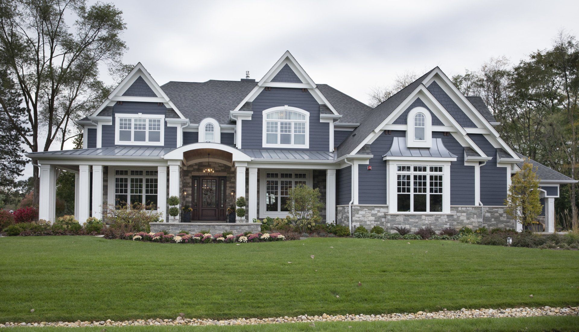 A large house with a lush green lawn in front of it