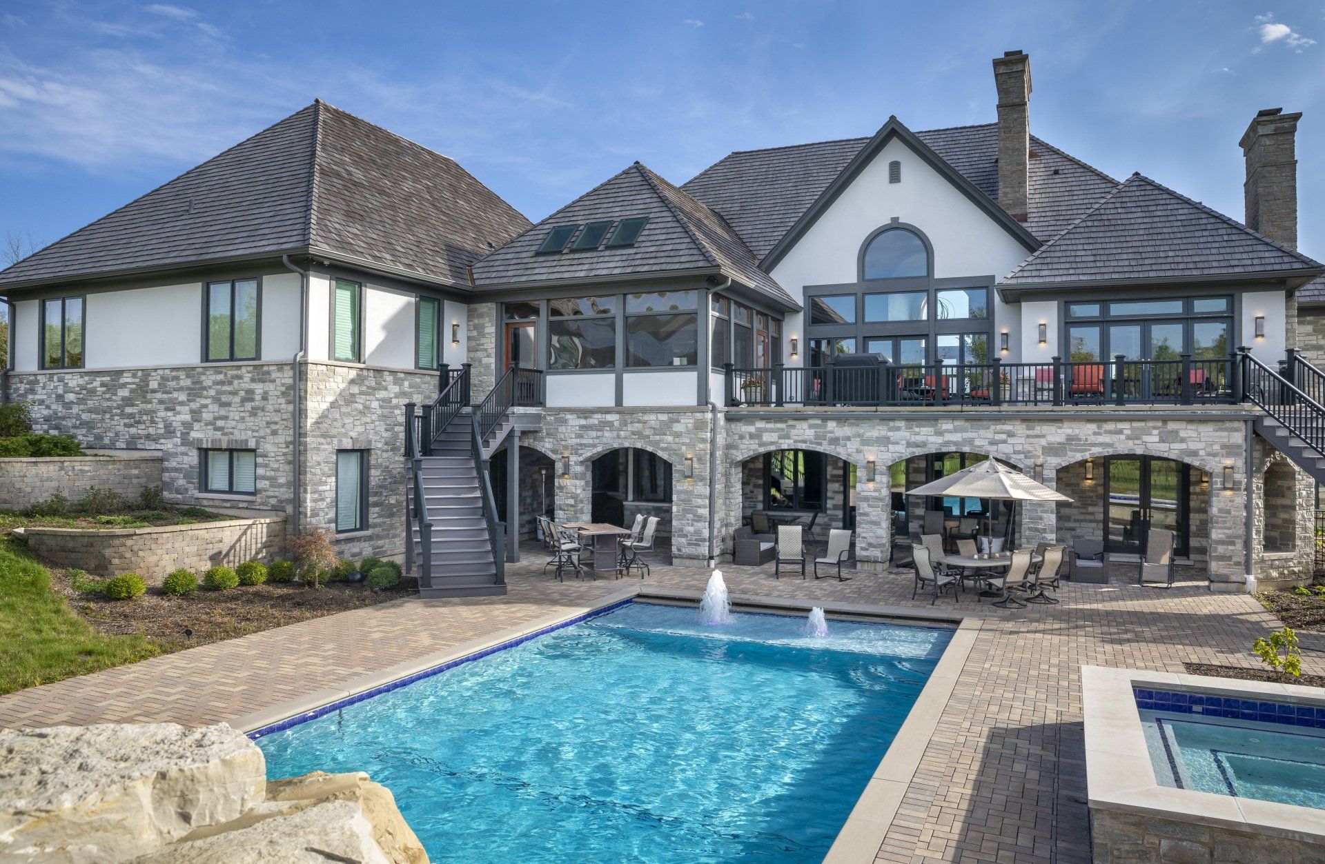 A large house with a large swimming pool in front of it