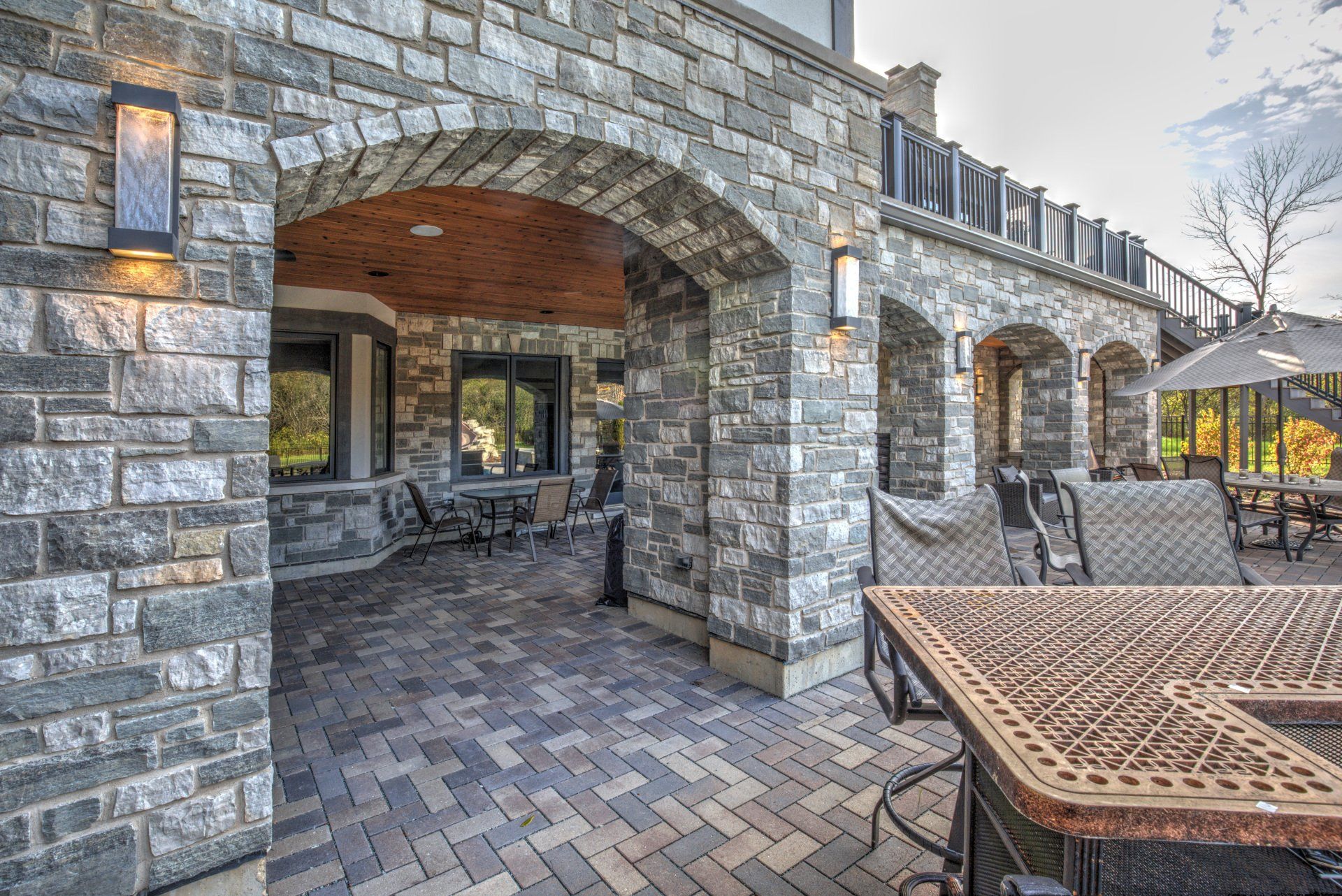 A brick building with a table and chairs in front of it.