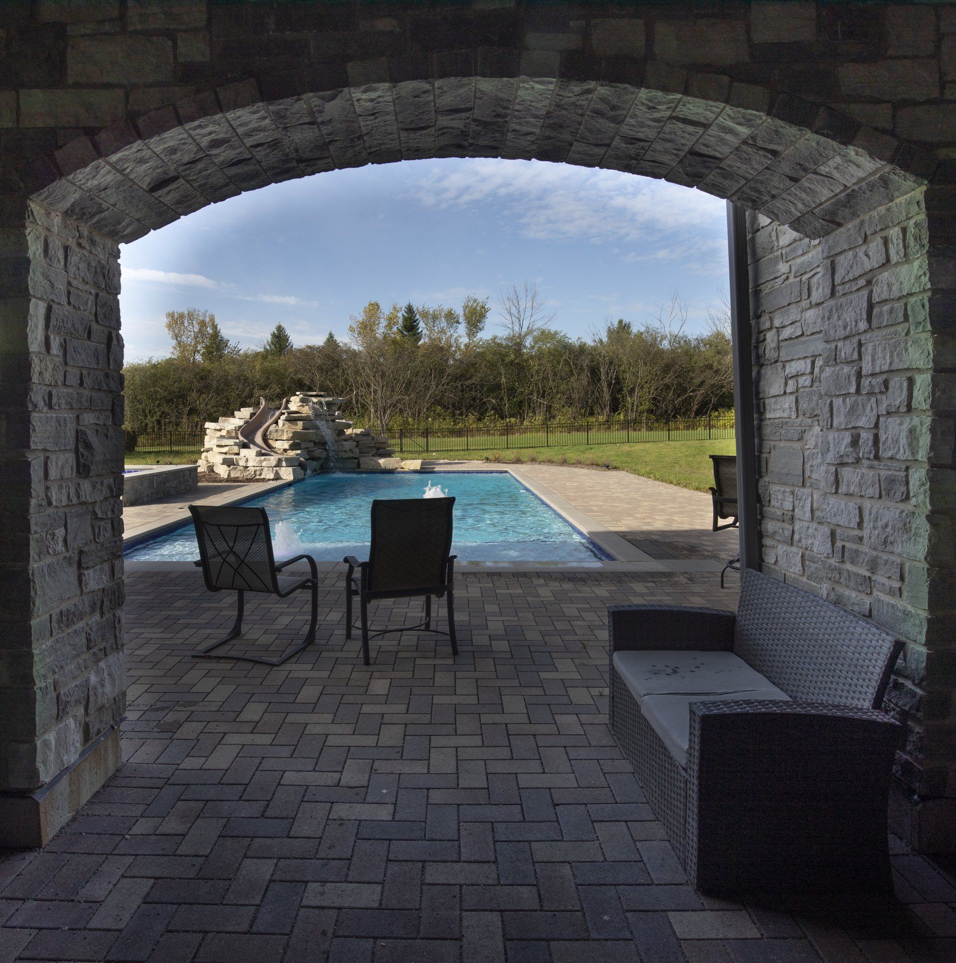 A view of a swimming pool through an archway