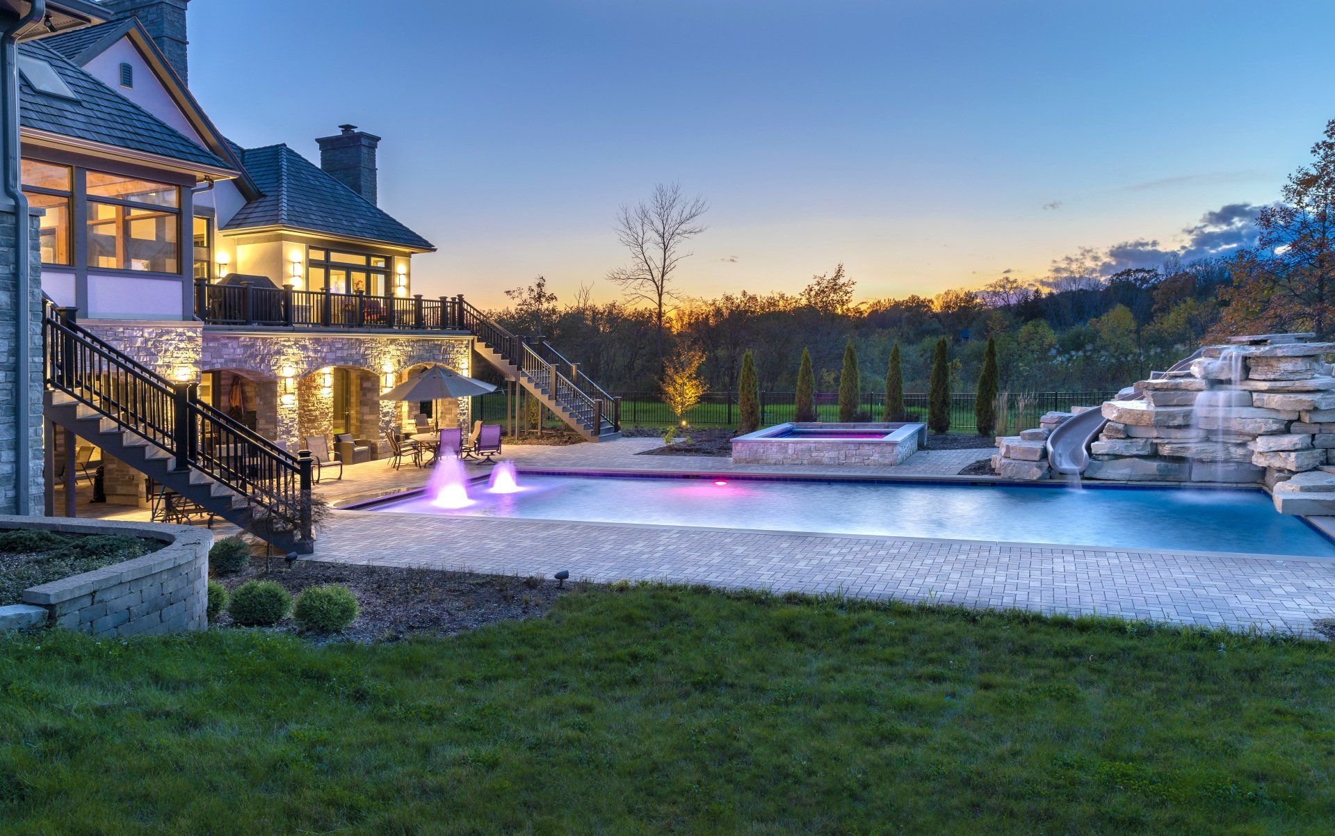 A large house with a large swimming pool in front of it.