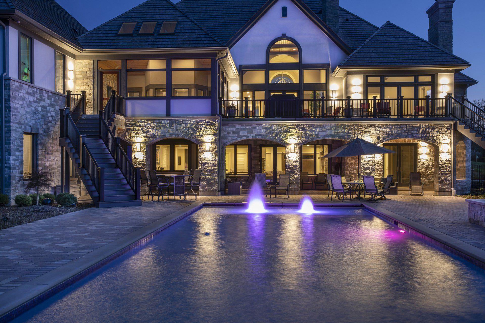 A large house with a swimming pool in front of it