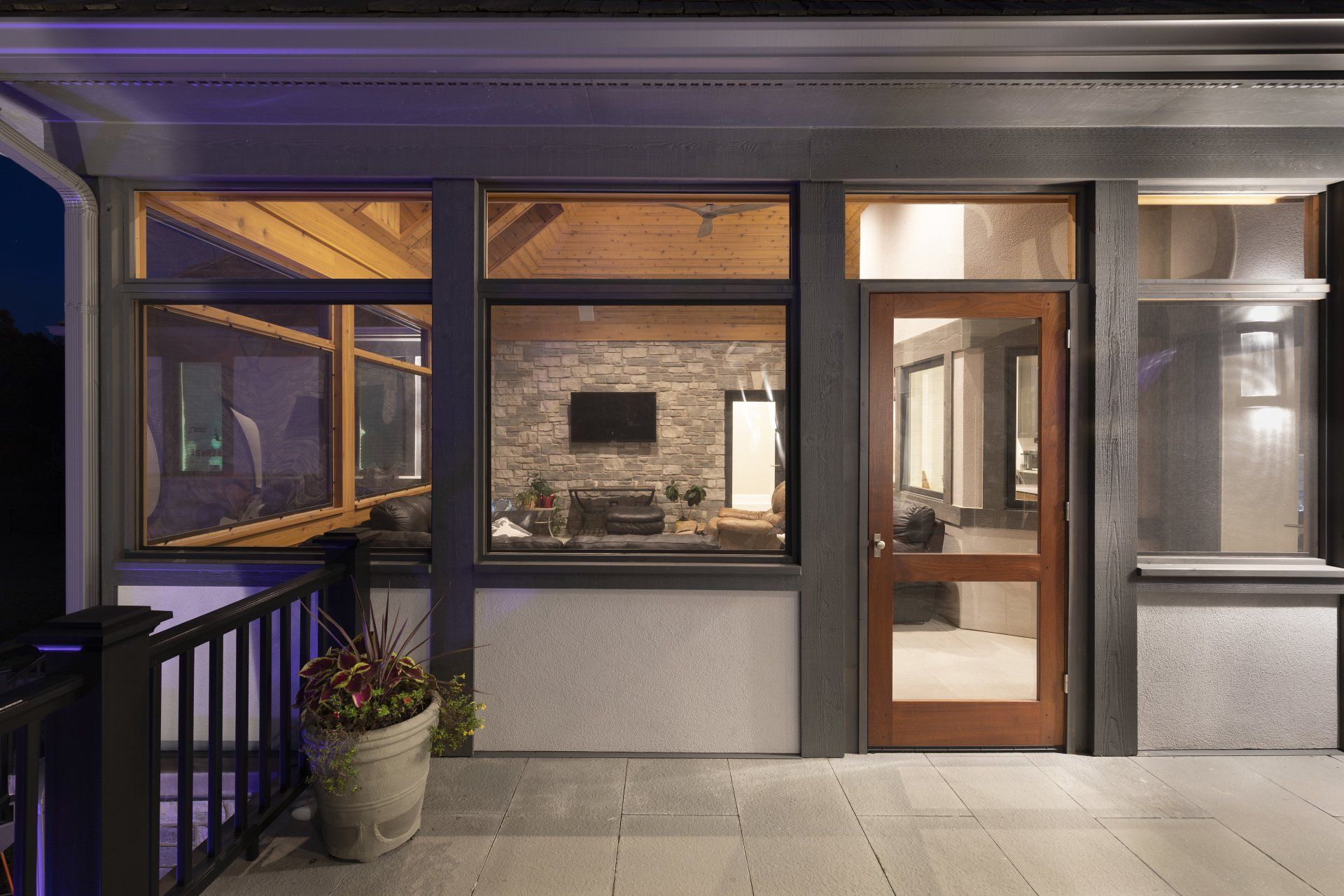 The front of a house with a large window and a door.