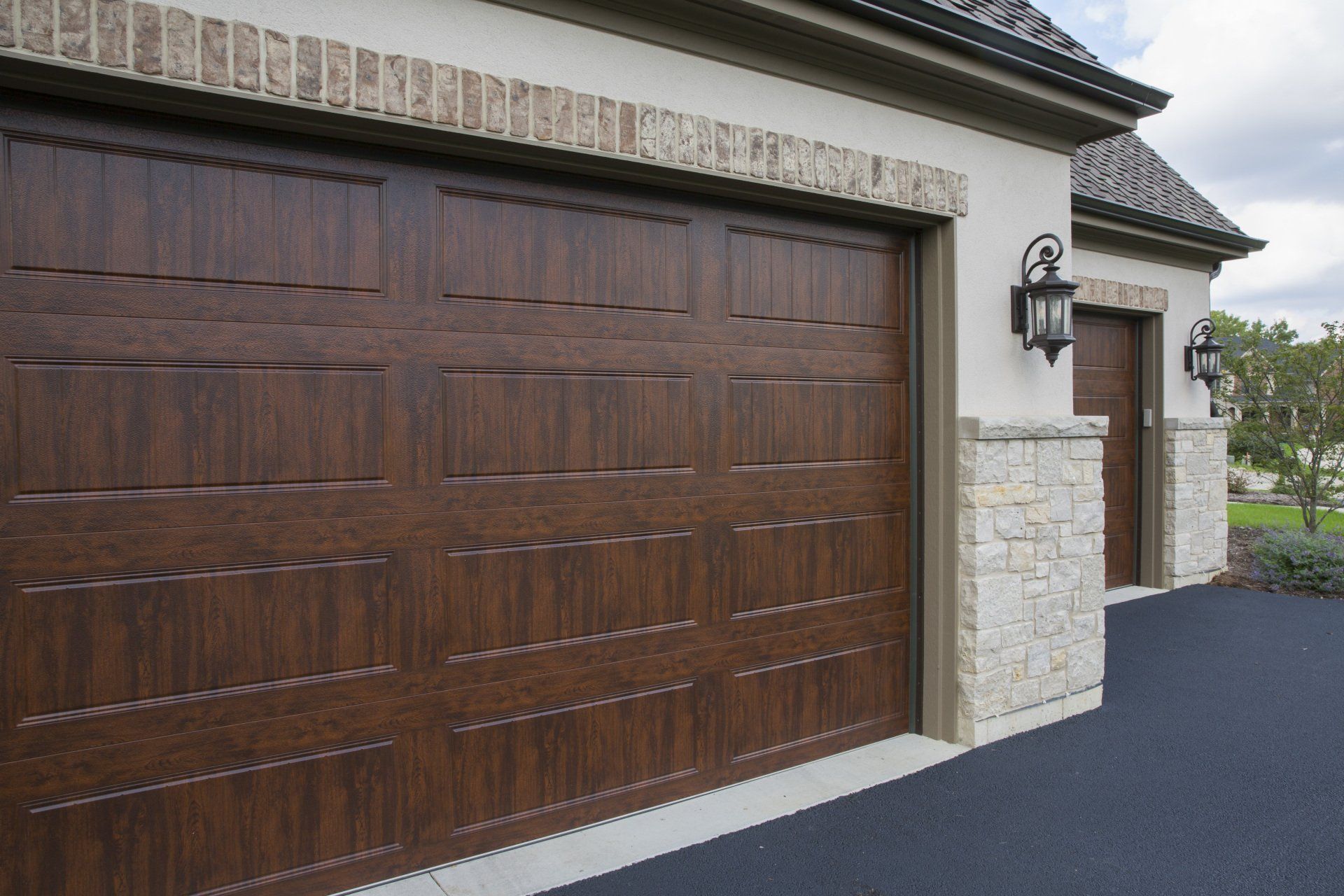 A garage with a wooden door and a stone wall