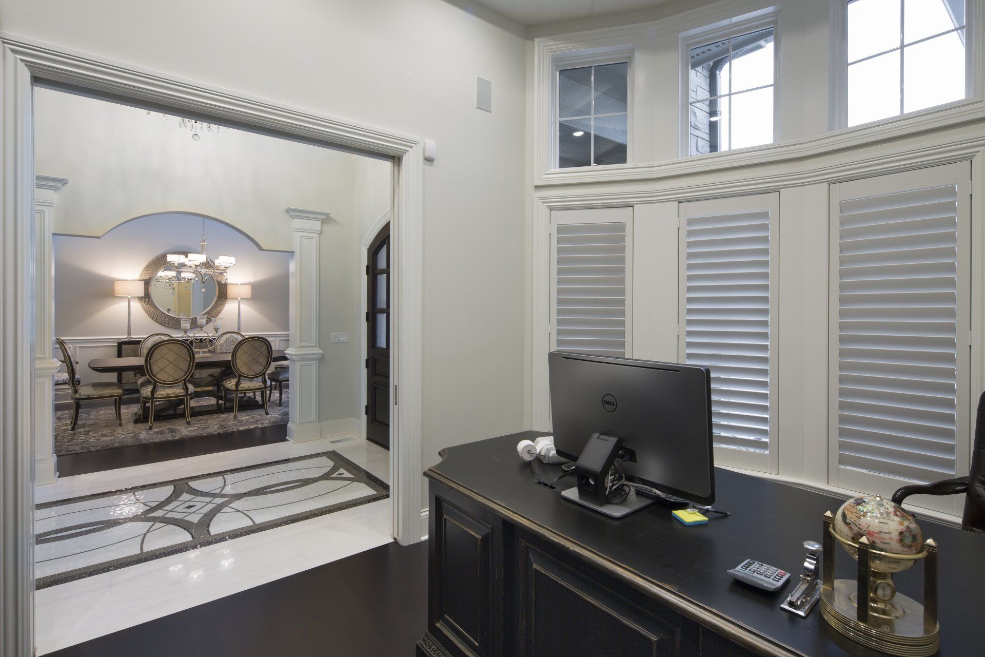 A room with a desk and a computer in it