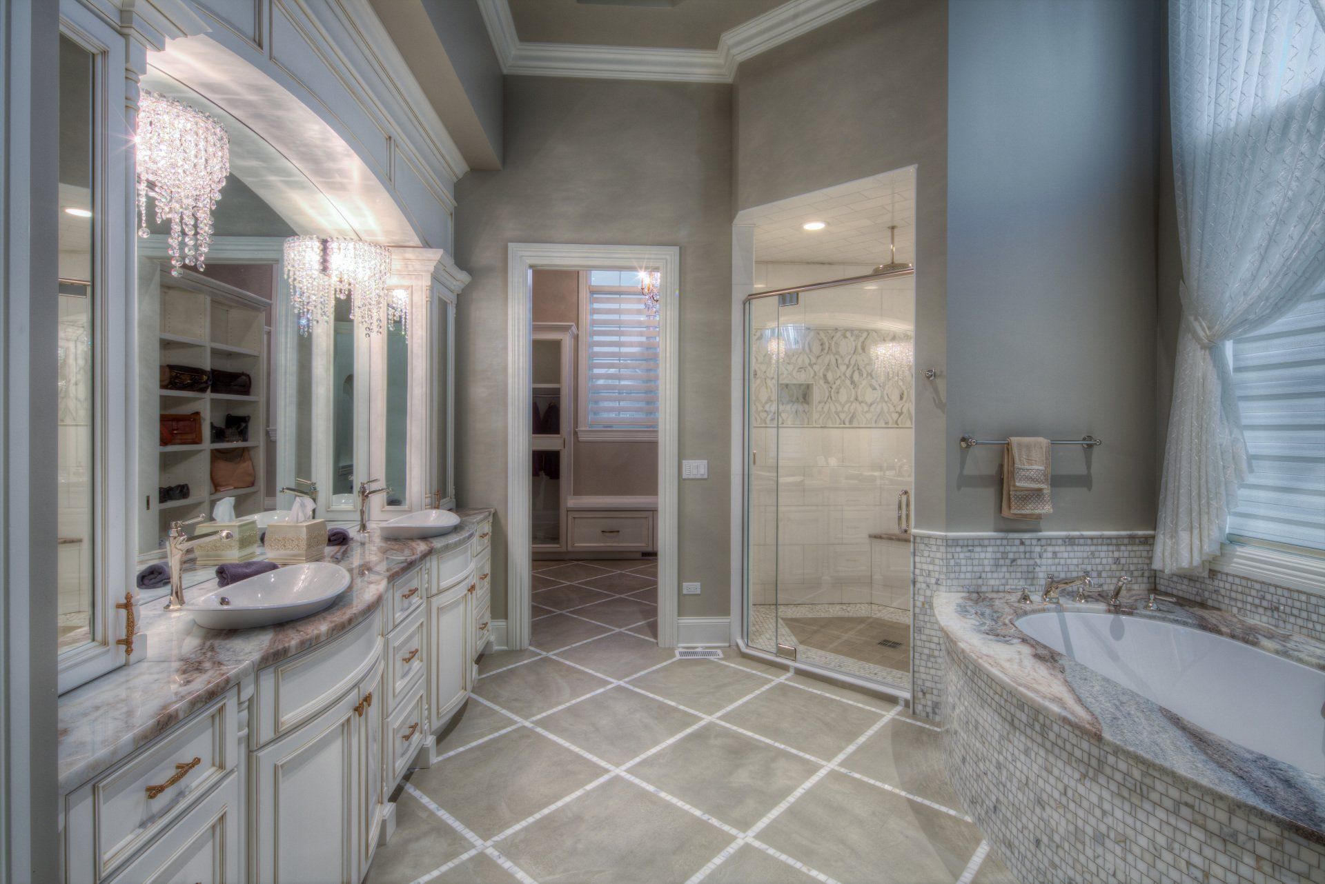 A bathroom with a tub , sinks , mirrors and a walk in shower.