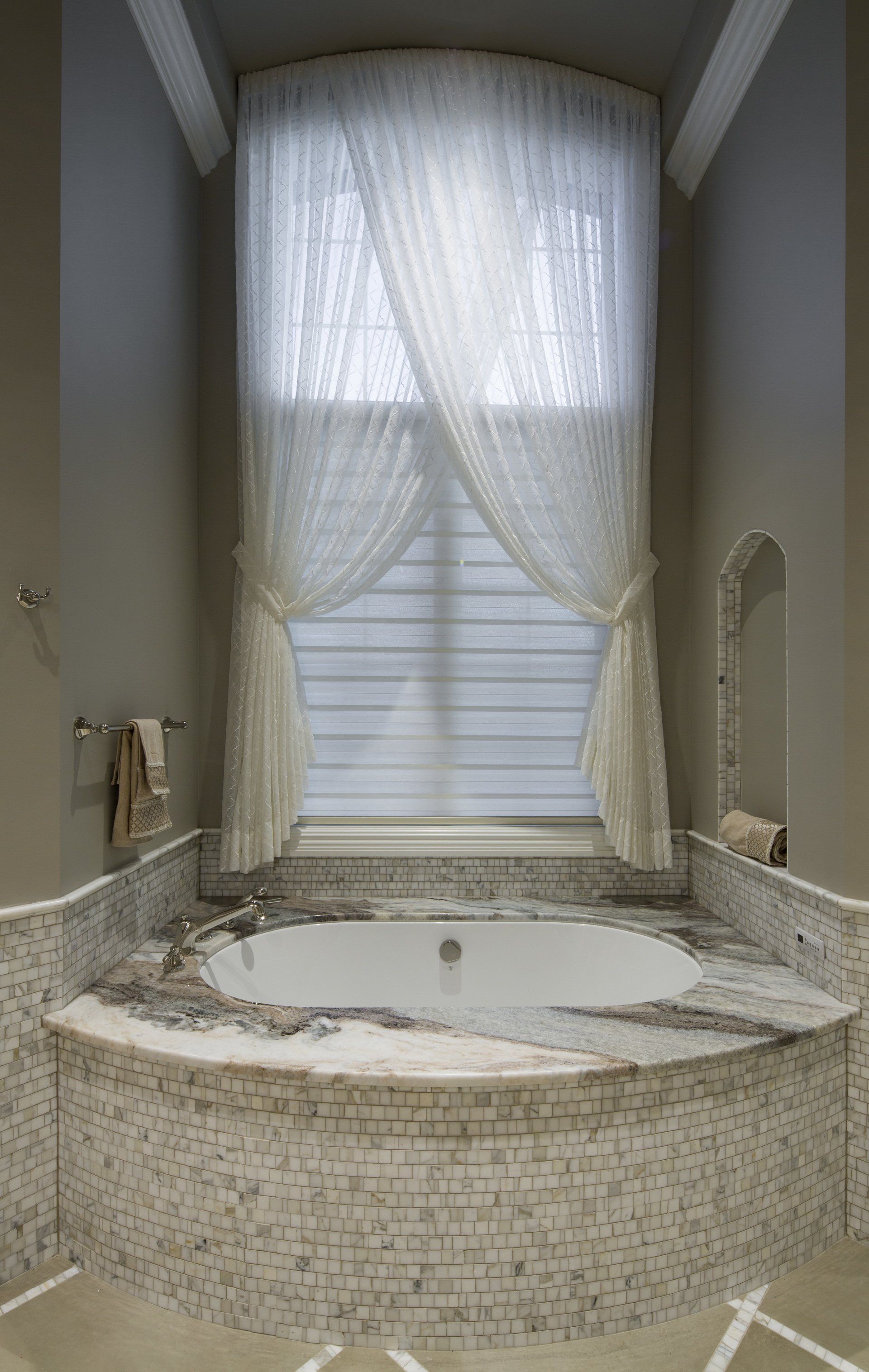 A bathroom with a jacuzzi tub and a large window.