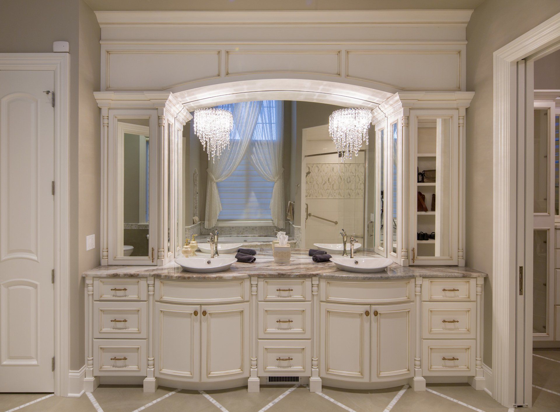 A bathroom with two sinks and a large mirror.