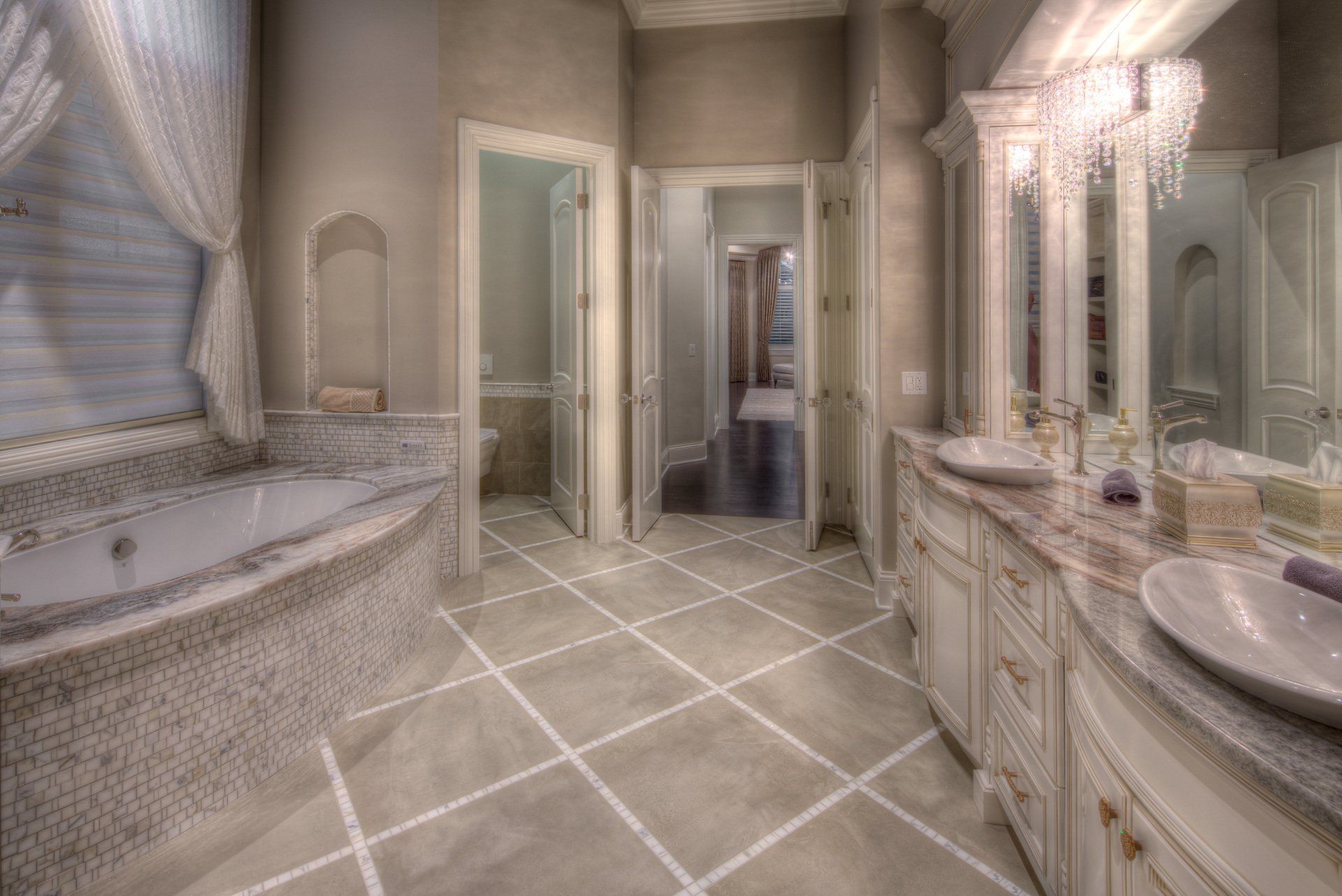 A bathroom with a bathtub , sinks , and mirrors.
