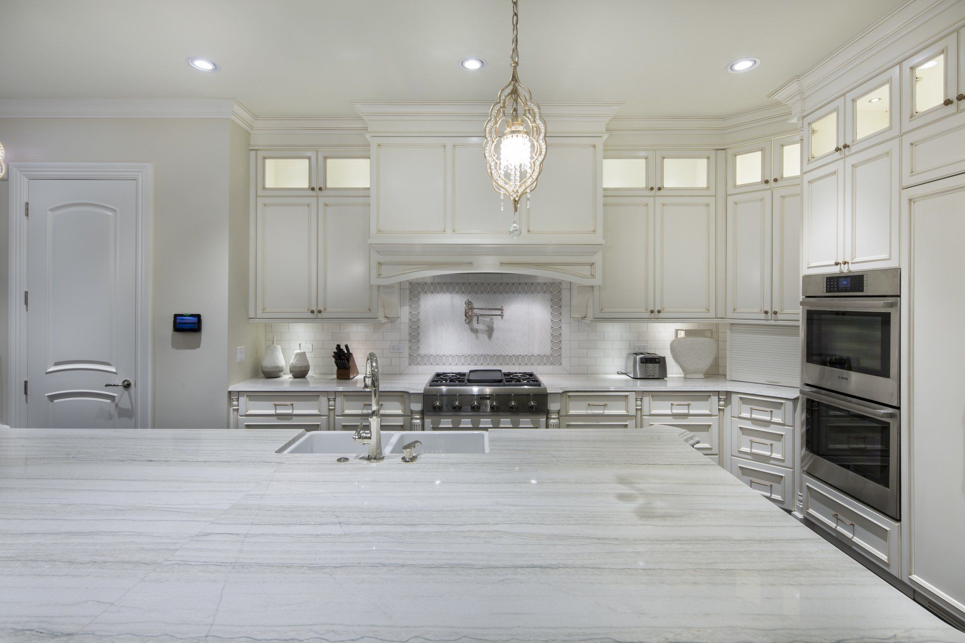A kitchen with white cabinets and stainless steel appliances
