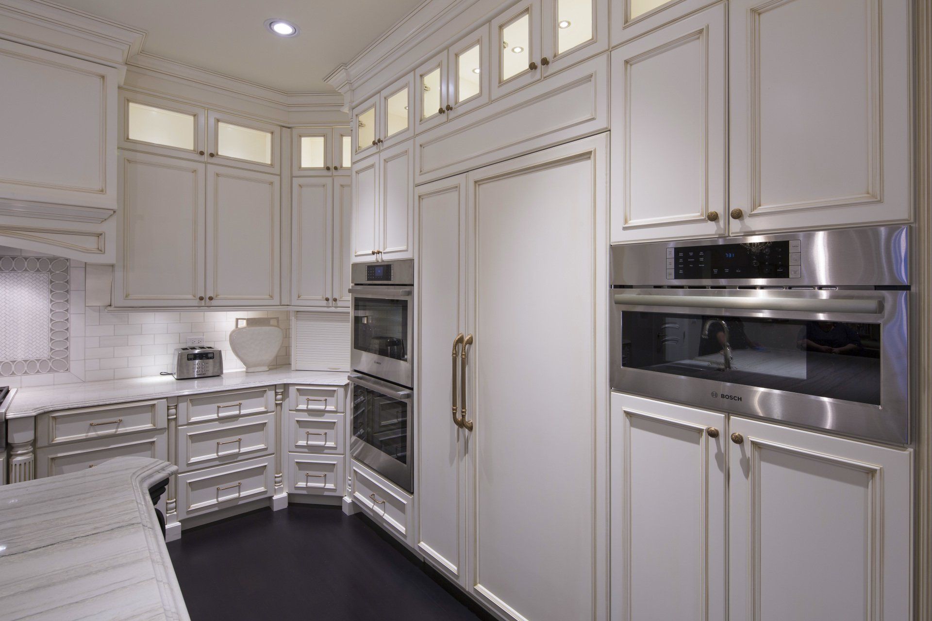 A kitchen with white cabinets and stainless steel appliances