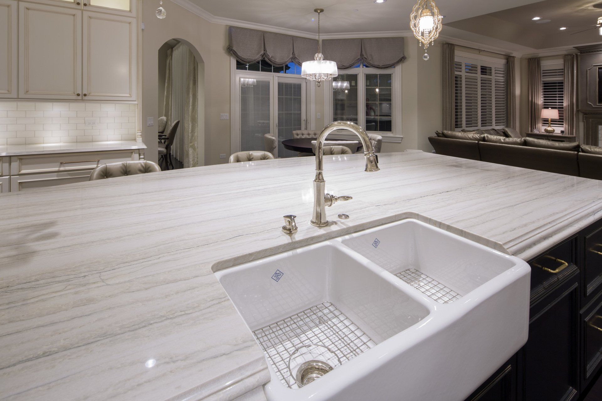 A kitchen with a double sink and a large counter top.