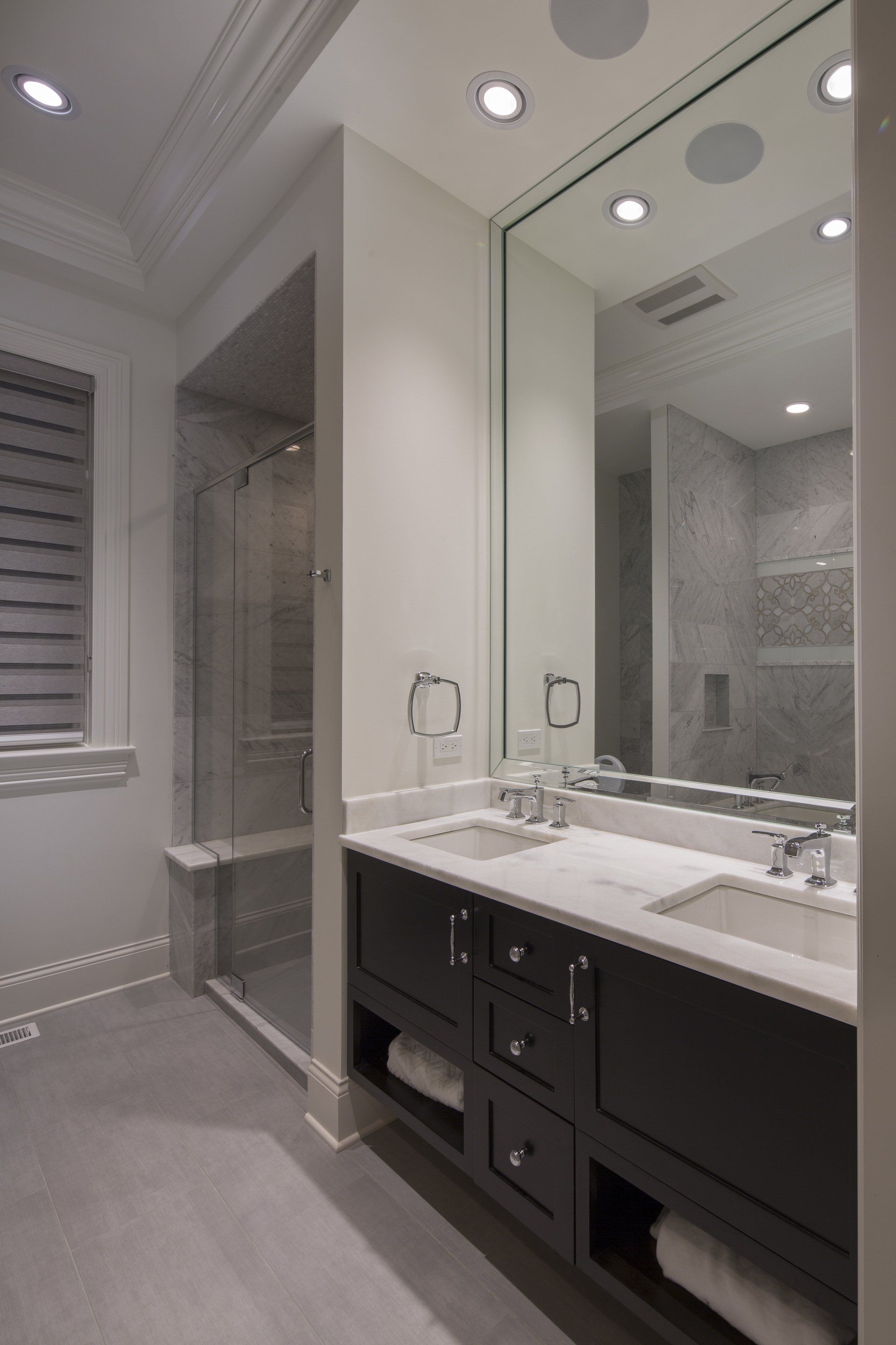 A bathroom with two sinks and a large mirror
