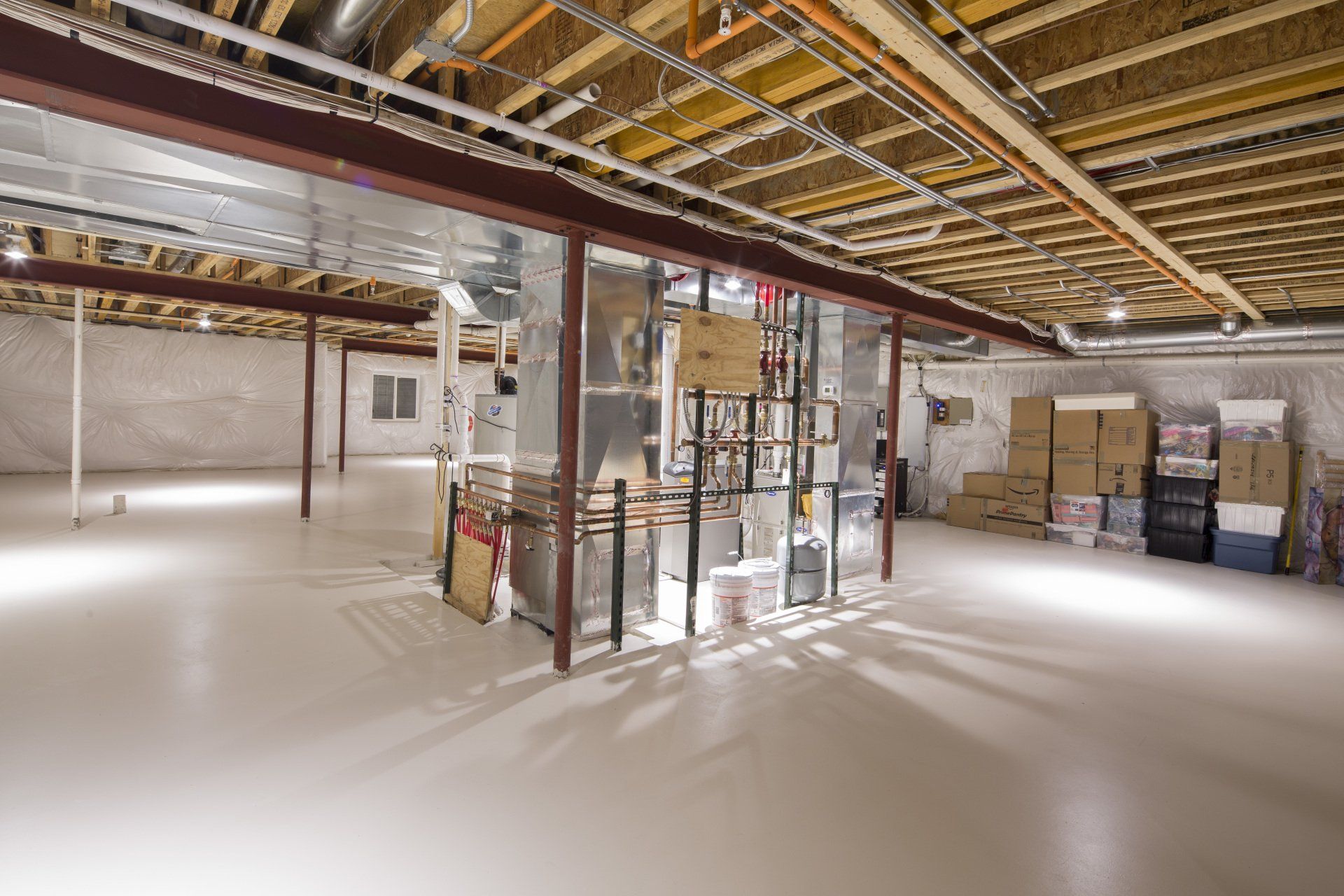 An empty basement with a lot of boxes on the floor.