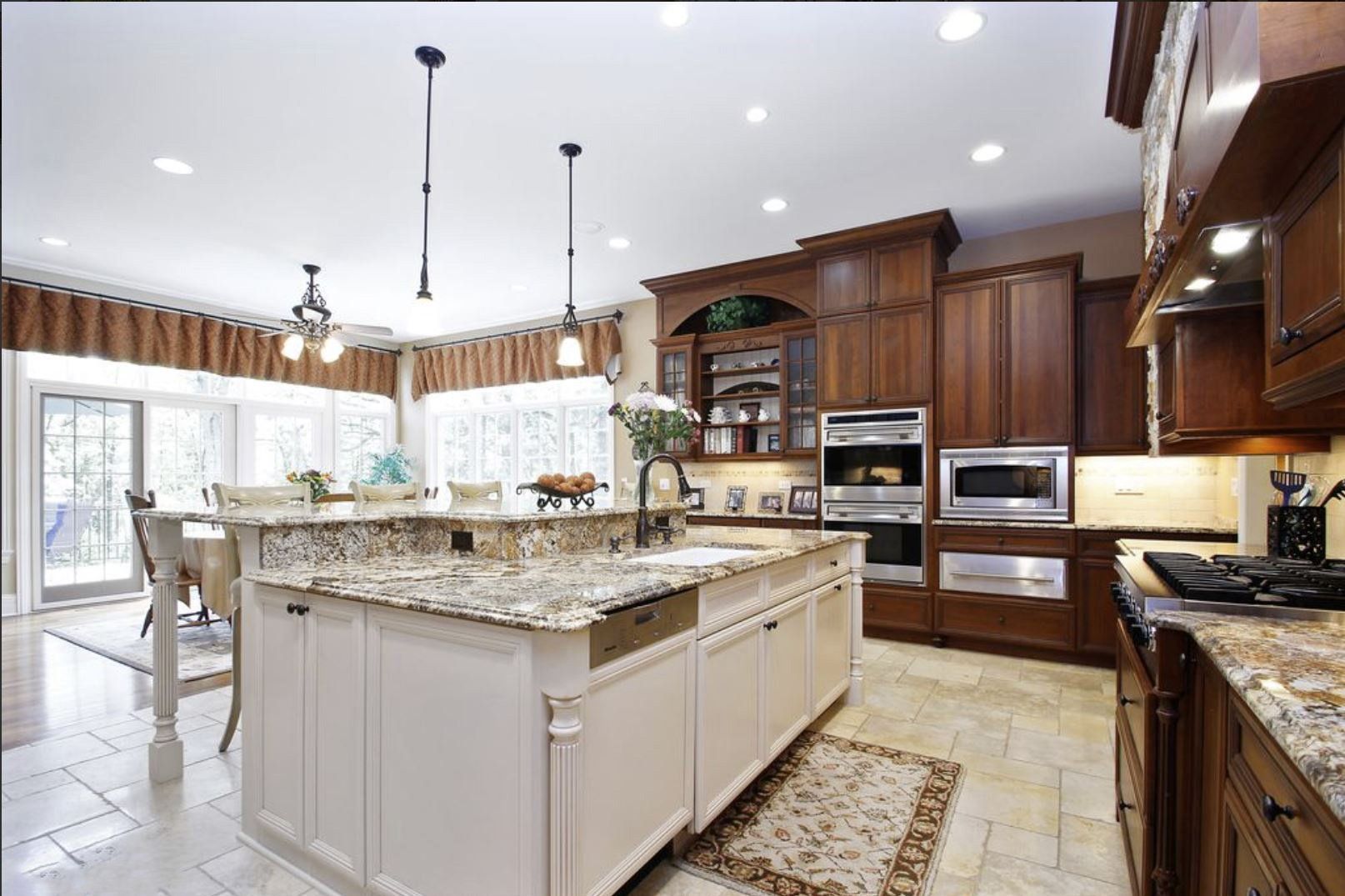 A kitchen with a large island and granite counter tops
