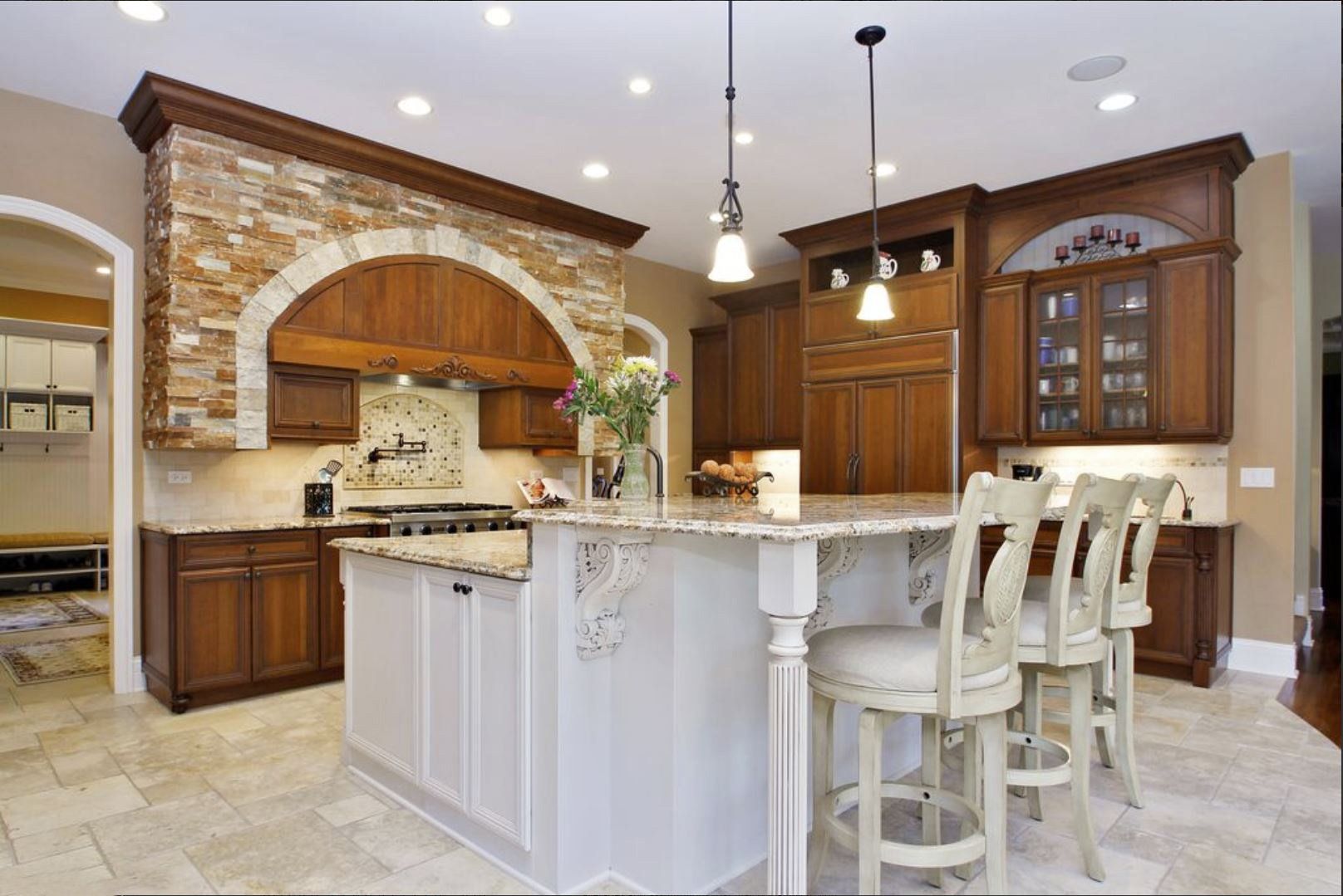 A kitchen with a large island and stools