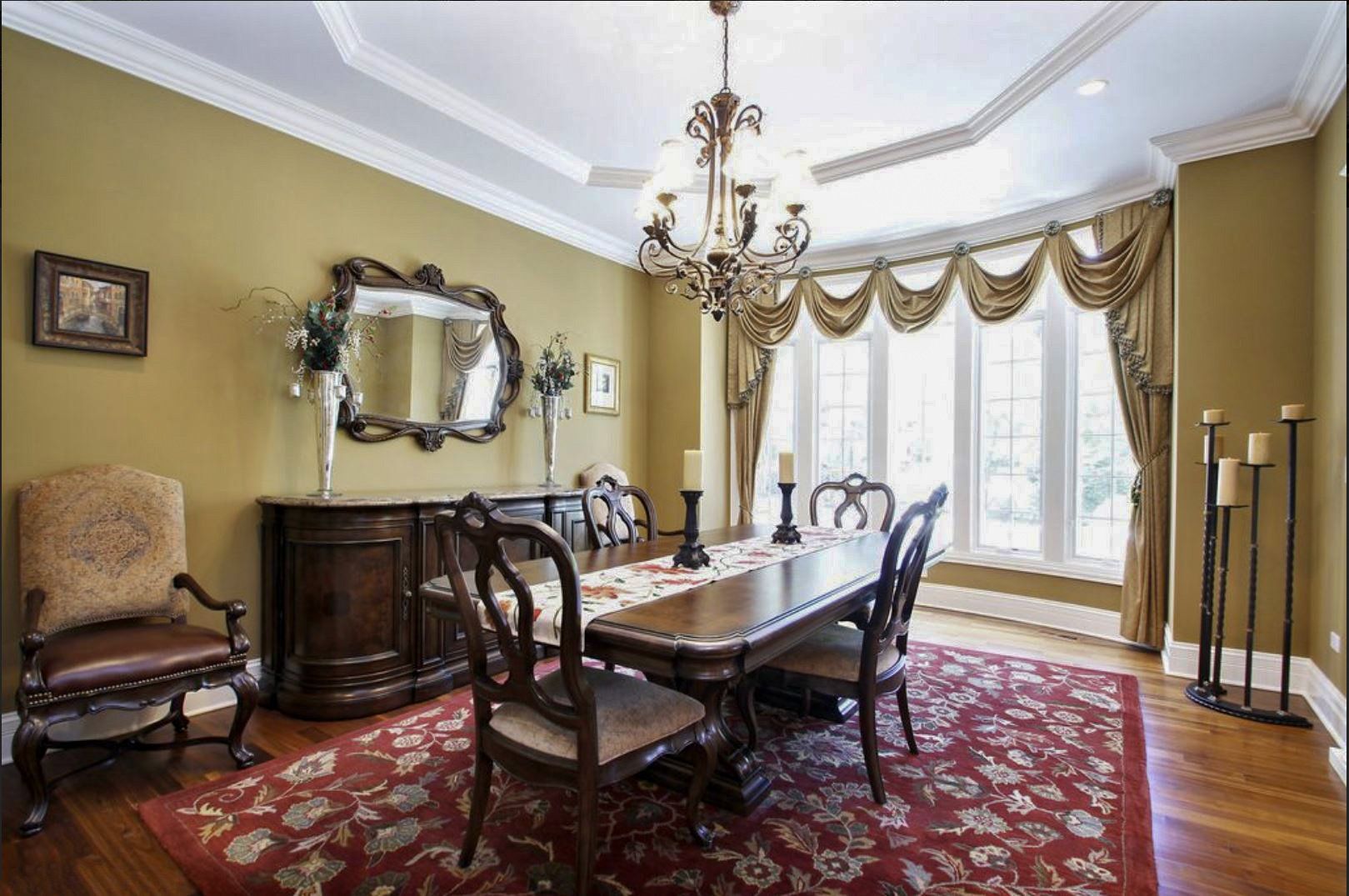A dining room with a table and chairs and a chandelier