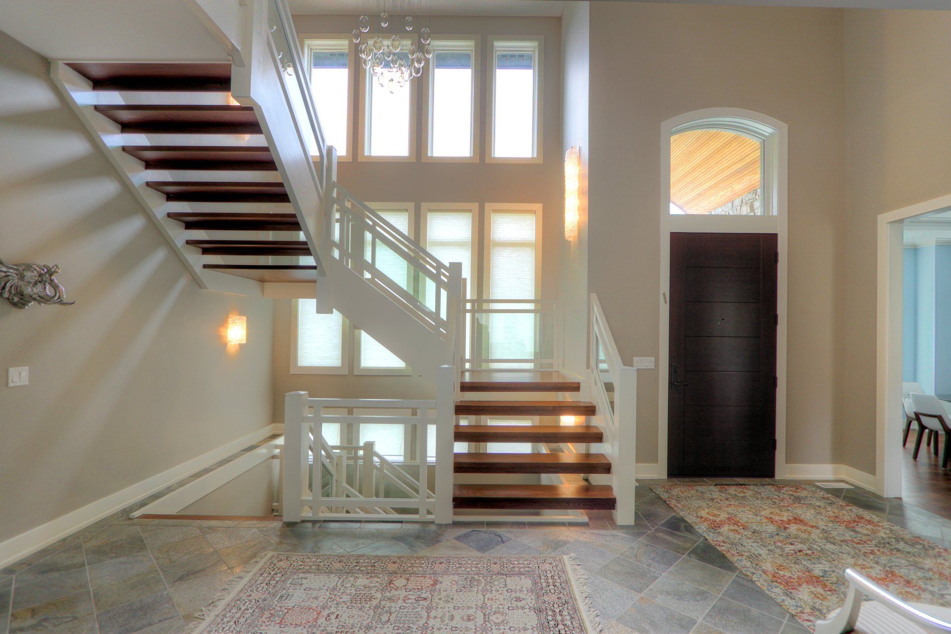A large staircase in a house with lots of windows